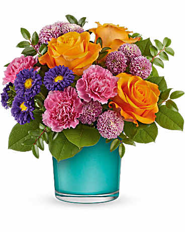 Bouquet of orange roses, pink carnations, and purple daisies in a turquoise vase