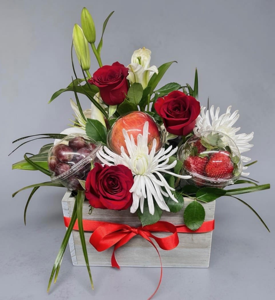 Mom's Berry Special Day - Flowers and something sweet! This Mother's Day special arrangement features fresh roses, lilies, and greenery, paired with delicious in season fruit in a keepsake box. A beautiful and thoughtful gift Mom will Love. Note: Fruit is arranged in individual sealed cups.