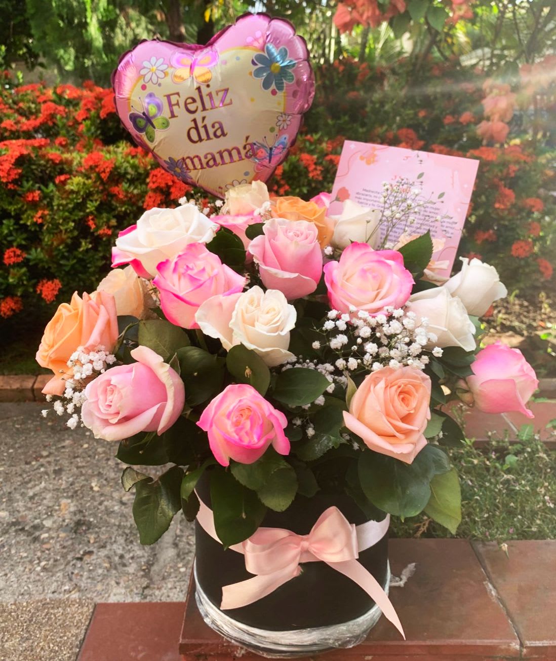 Lazzo Box - Round Black Box of 24 Roses ( PINK, CREME, PEACH)  greeneries with accents of baby breath and a Mini Mother's Day Balloon. Bouquet will be delivered approximately as pictured. *** Flower color may vary depending on availability *** 