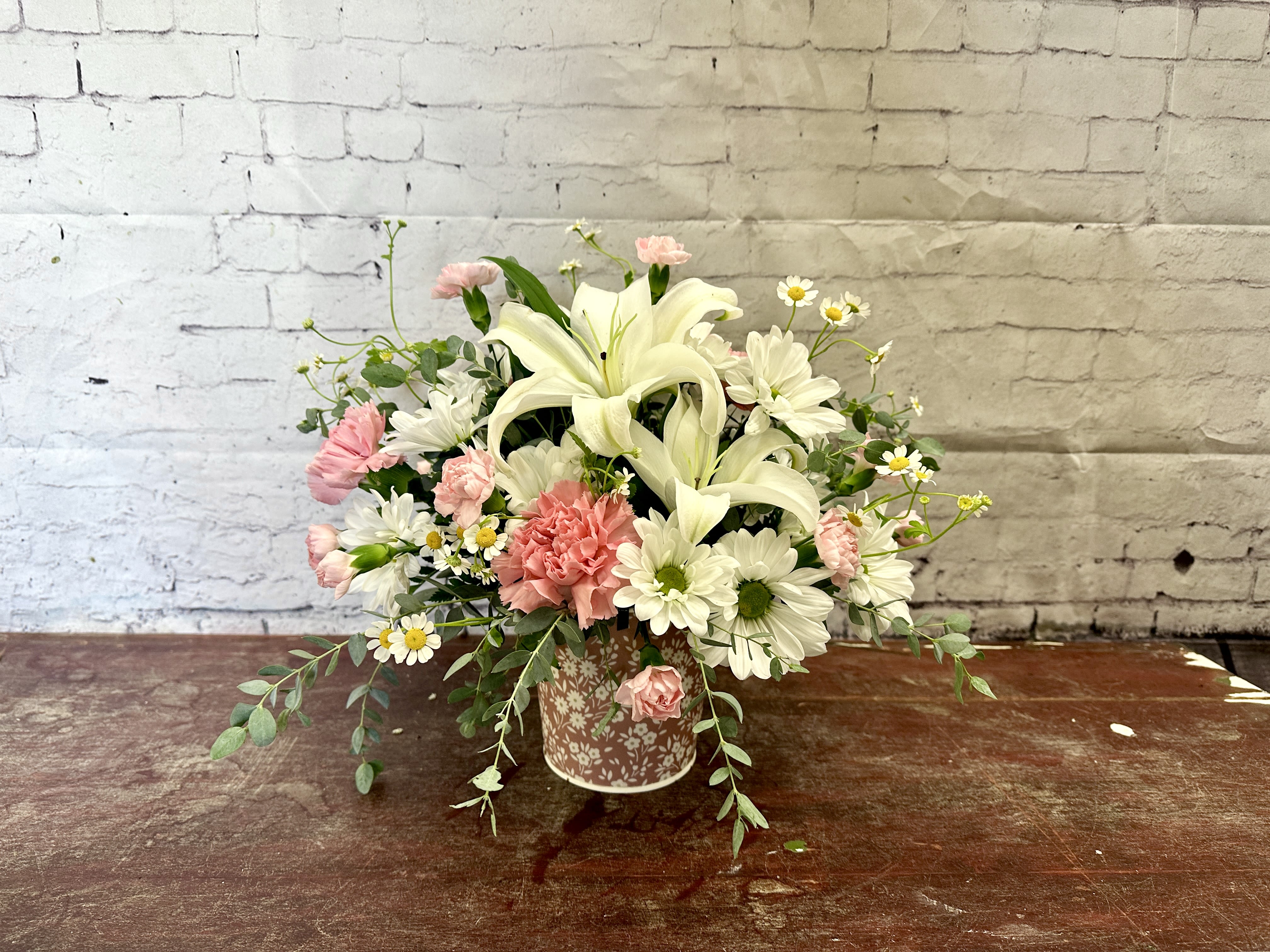 A mother’s touch  - White lilies, pink carnations and daisies in a dusty pink floral tin 