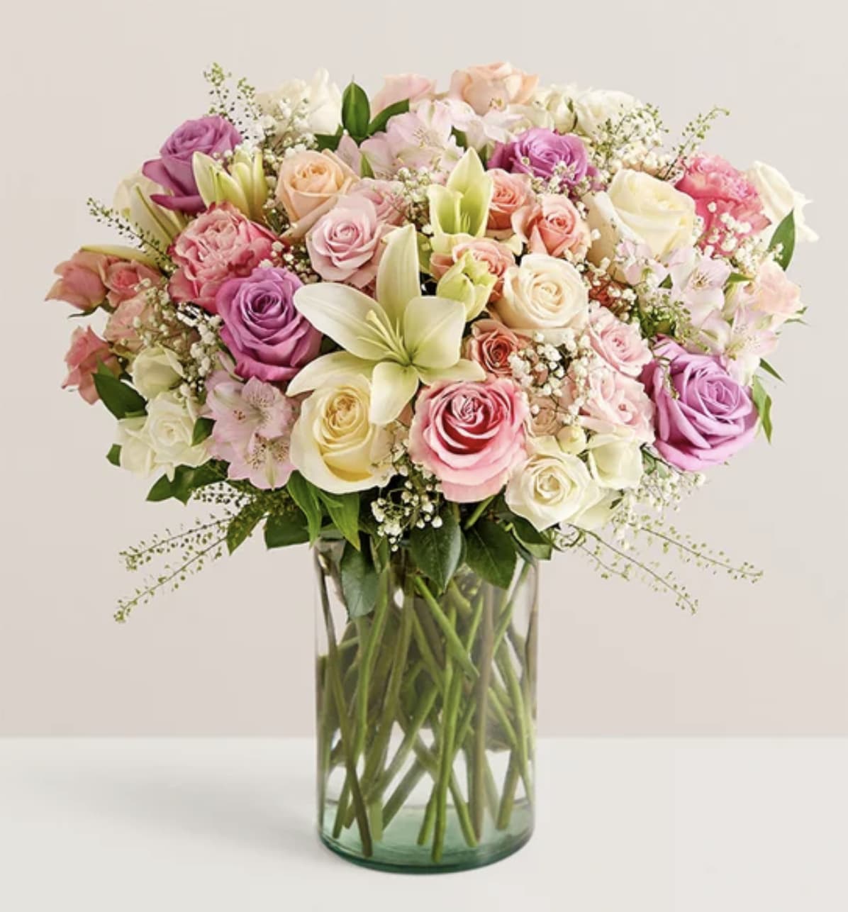 Spectacular Mom Bouquet - A bouquet like no other, for a Mom who is one of a kind. More than three dozen roses—including ombré frutteto and blissfully fragranced Tiffany roses—in glorious shades of pink, peach, lavender, and white are accented with lilies, baby’s-breath, and greenery. Lavish and luxurious, this is an arrangement she will always remember and never stop enthusing about.