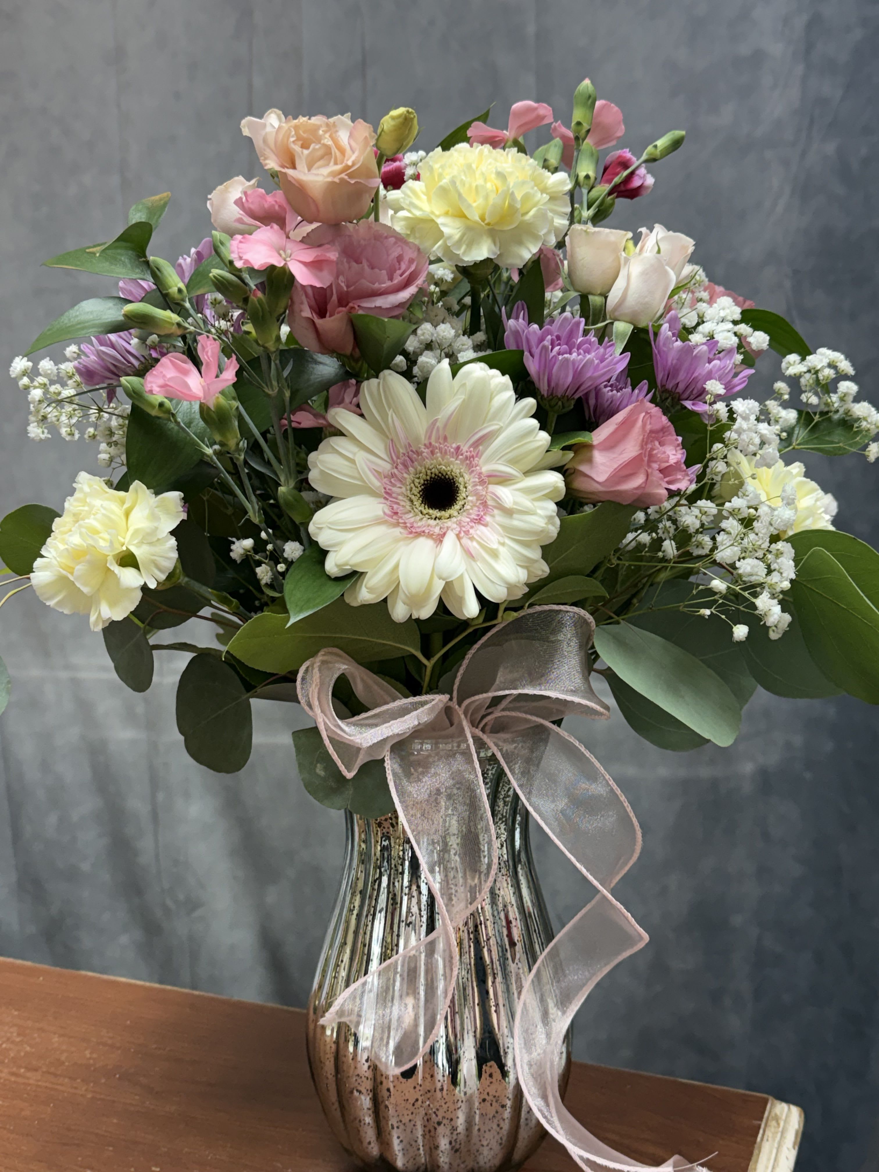 Pastel petal harmony - Soft pastel mix of gerbera, roses, carnations and blooms beautifully arranged in a glass vase with ribbon perfect for any occasion 