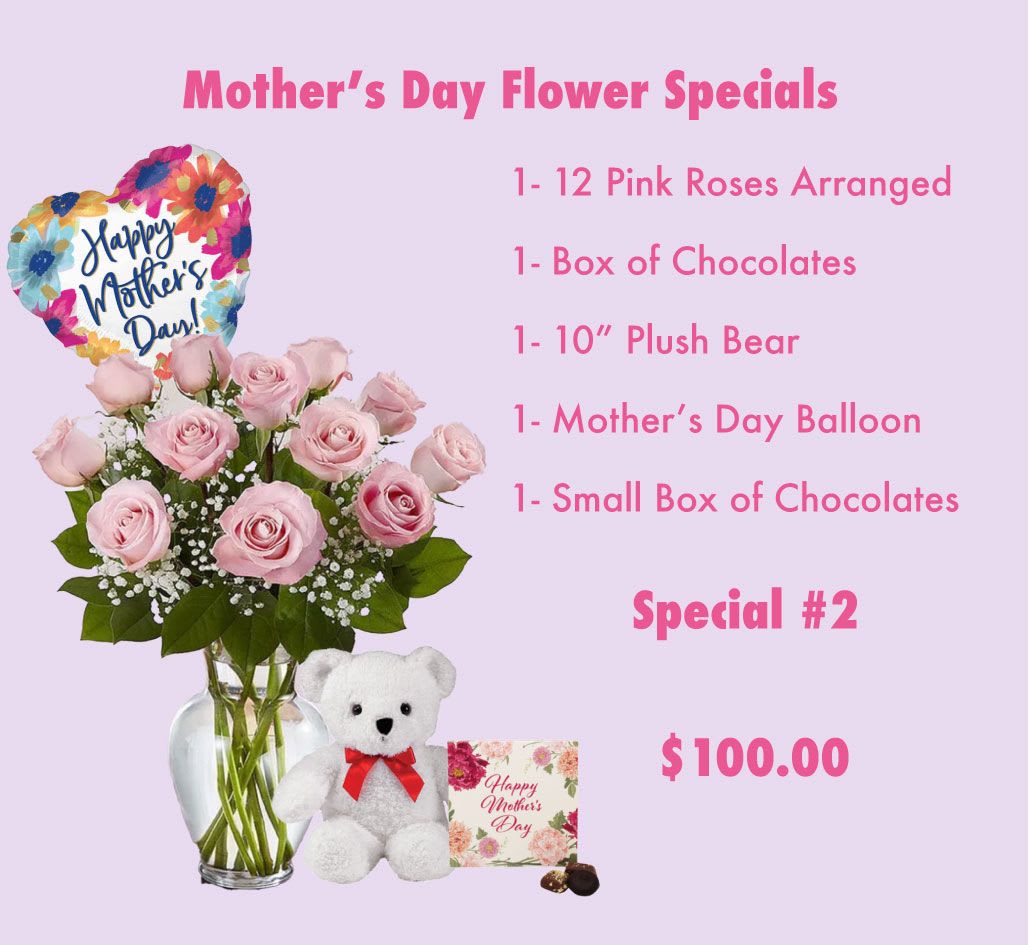 Pink roses in a glass vase with a heart balloon, teddy bear, and chocolates