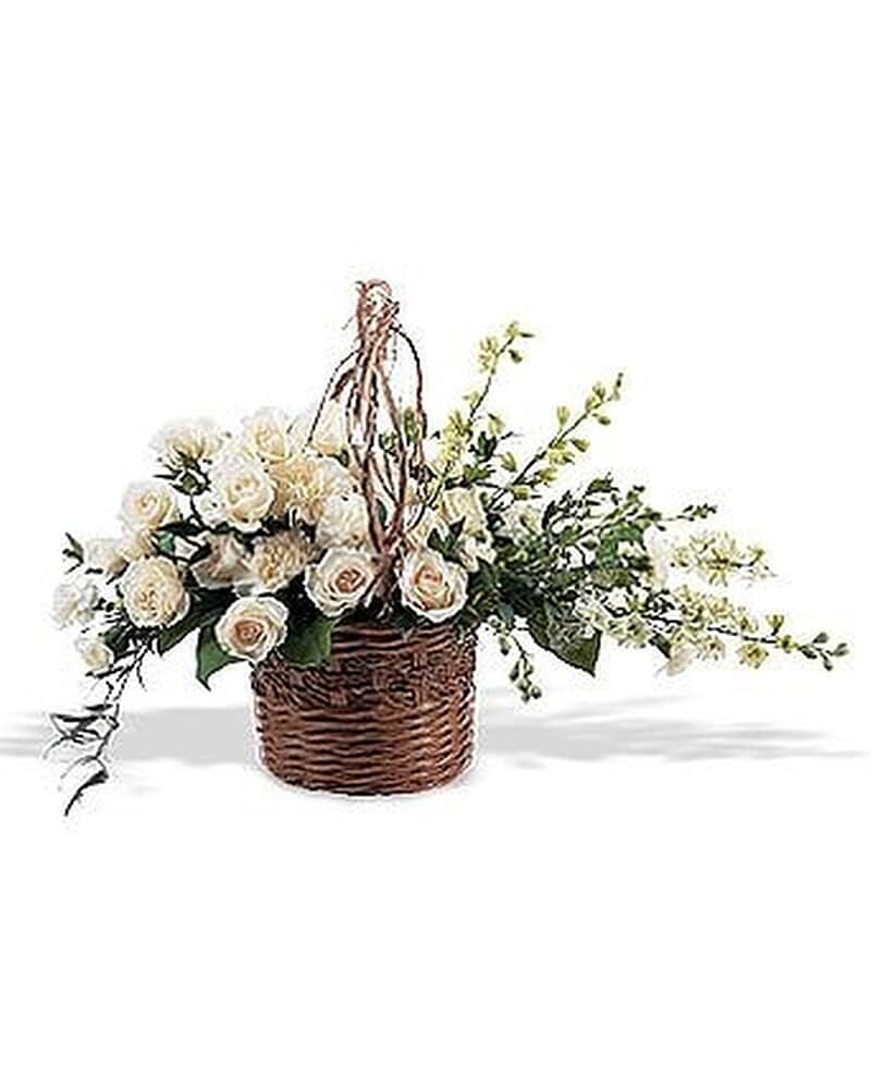 Basket arrangement of white roses and blossoms with trailing stems in an asymmetrical design