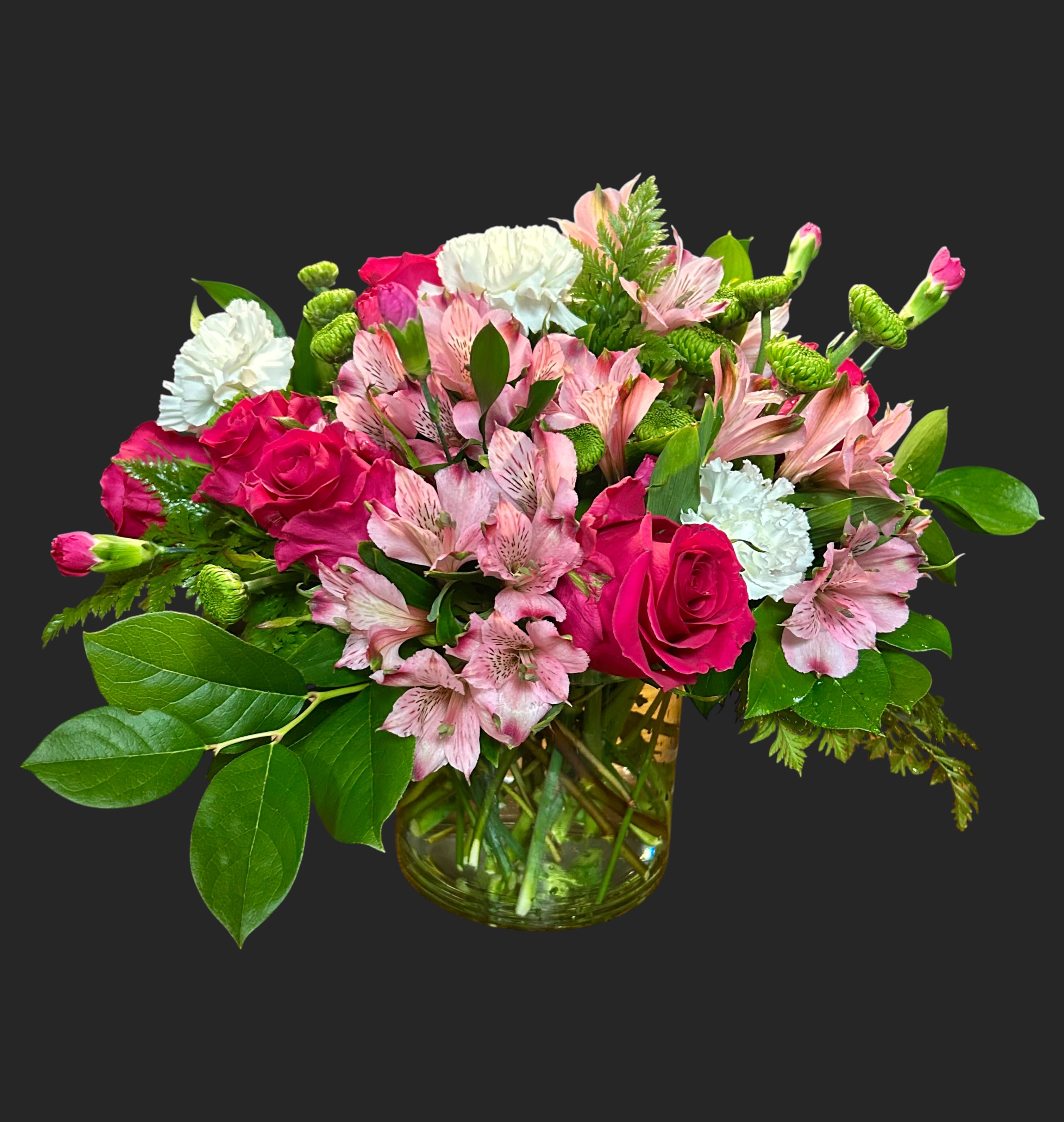 Pink roses and alstroemeria in a glass vase with white carnations