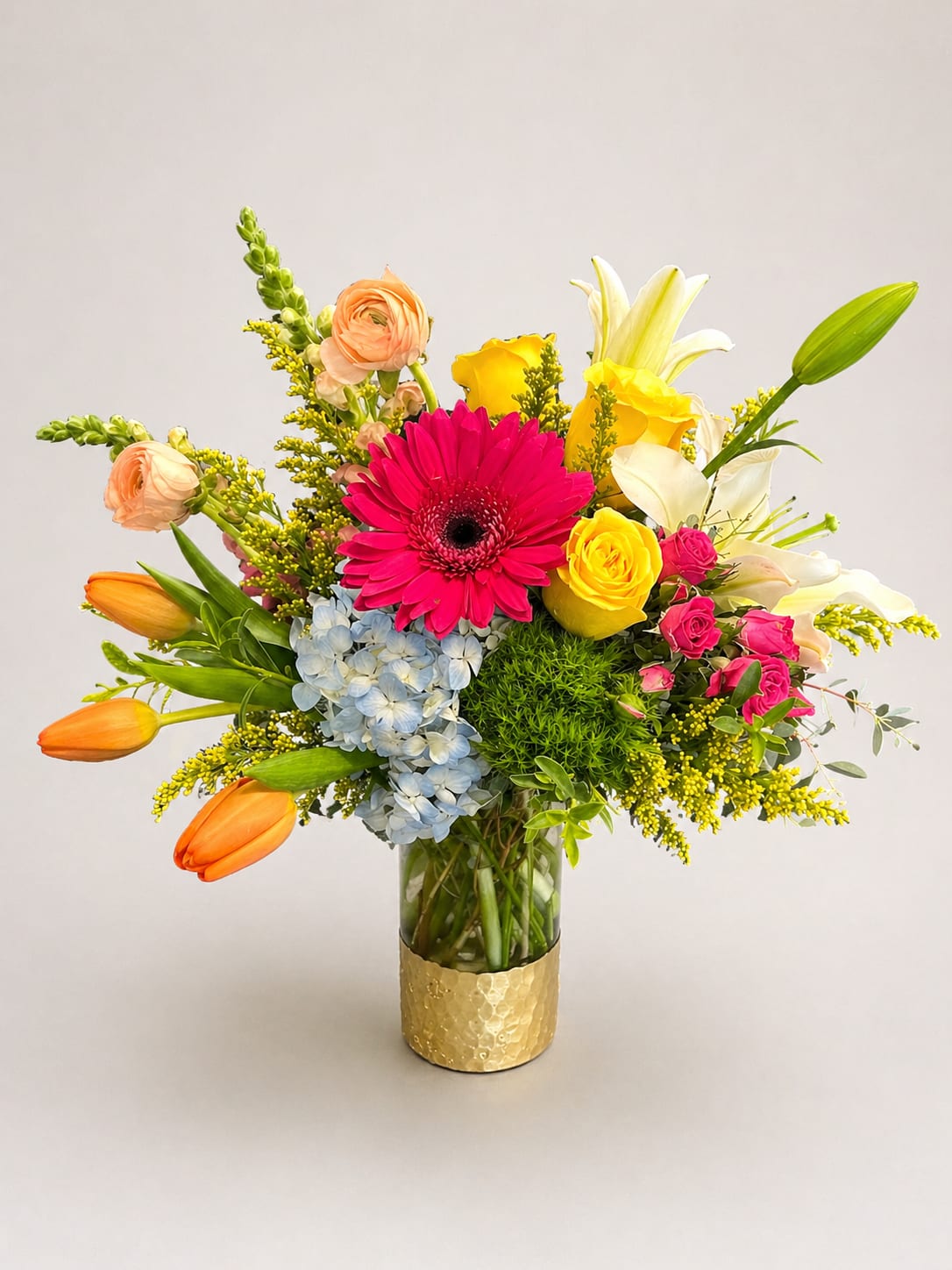 The Mom-osa  - A vivid hot-pink gerbera daisy takes center stage in this bright, celebratory flower arrangement-perfect as a cheerful birthday bouquet or a Mother's Day surprise. The Mom-osa arrangement blends pink, yellow, orange and white blooms for a sunny, uplifted look that says "you're special" to the person you're thinking of.