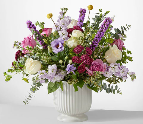 Work of Art Bouquet - This grand bouquet of purple, lavender and ivory blooms is an exquisite way to show you are thinking of them. With roses, eucalyptus, stock, and a bit of greenery. Add a balloon to make this the perfect Mother's day gift