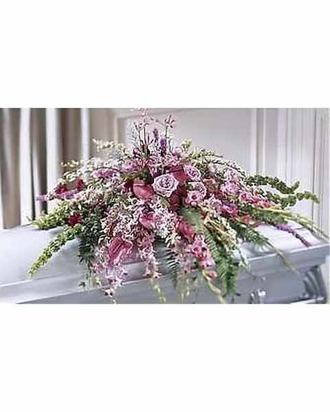 Thoughful Gestures Casket Spray - This thoughtful gesture of sympathy displays and abundance of purples and lavenders, using Roses, Orchids and many other outstanding floral blooms, as a grand casket spray.Approx. 25' H x 54' W 