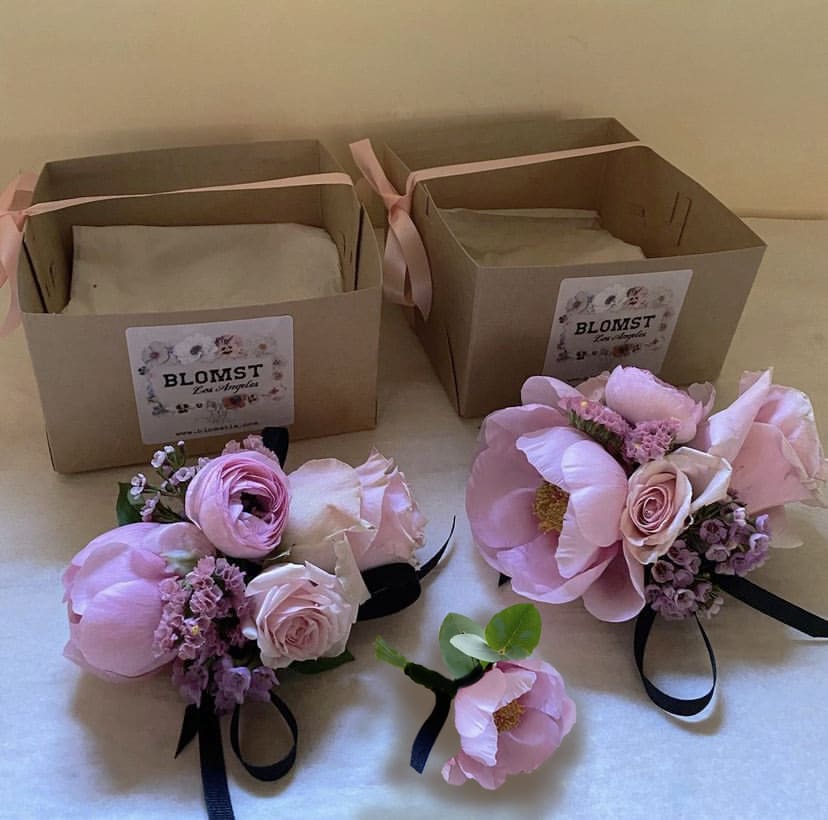 Corsage &amp; Boutonniere - One wrist corsage and one boutonniere for prom, dance, graduation, party, wedding. The cutest pair hand made of fresh seasonal stems. Make a note for Blomst at checkout for any special wishes for colors. Choose Deluxe for 2 wrist corsages and one bouttoniere and Premium for 2 wrist corsages and 2 boutonnieres. (The picture is Deluxe). Packed in a nice box for hand dellivery in LA