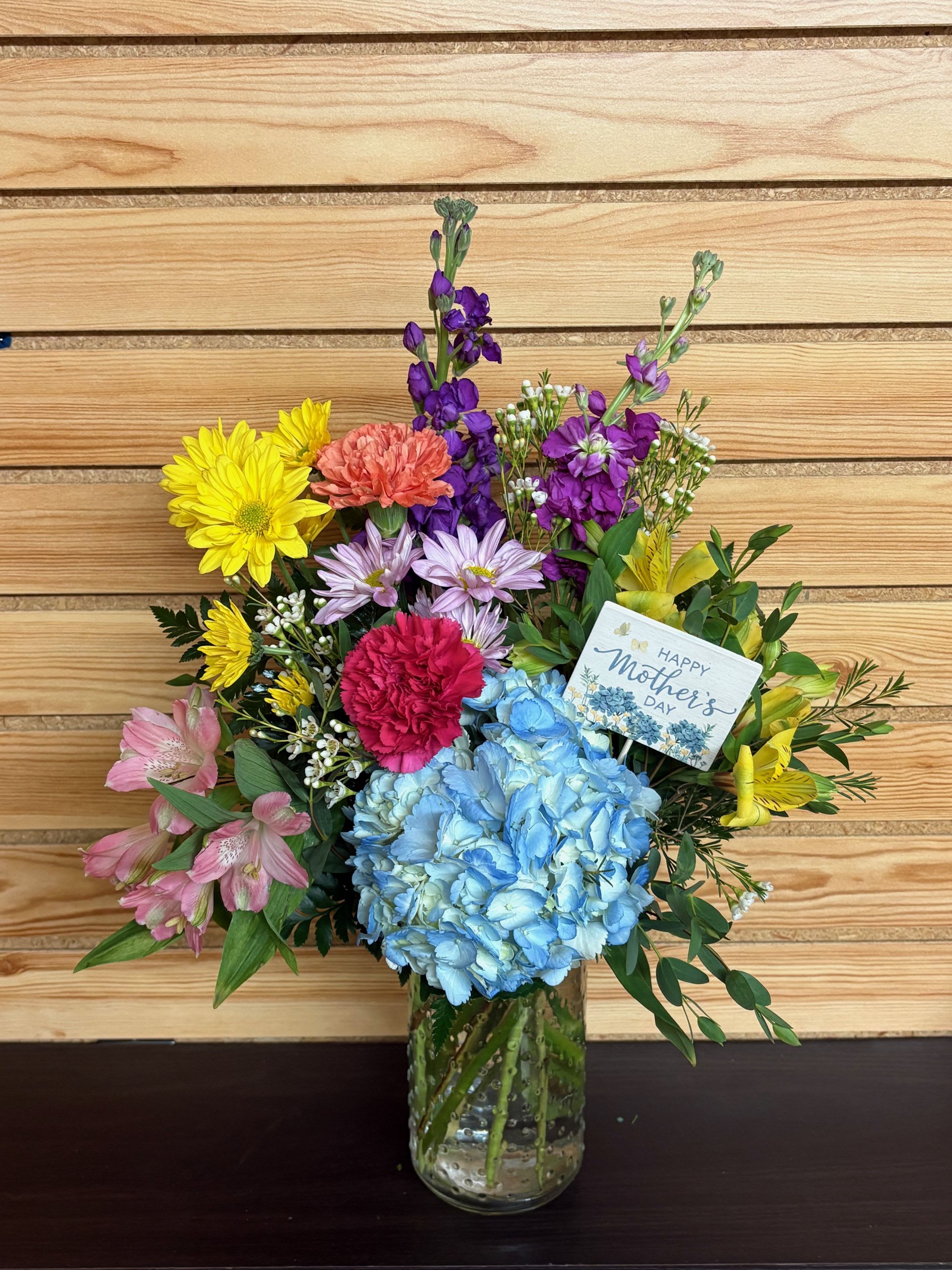 Mother's Garden - Show Mom how much you love and appreciate her with a Mother's Garden! Coming in a fun hobnail jar, there is hydrangea, colorful carnations, alstroemeria and stock!
