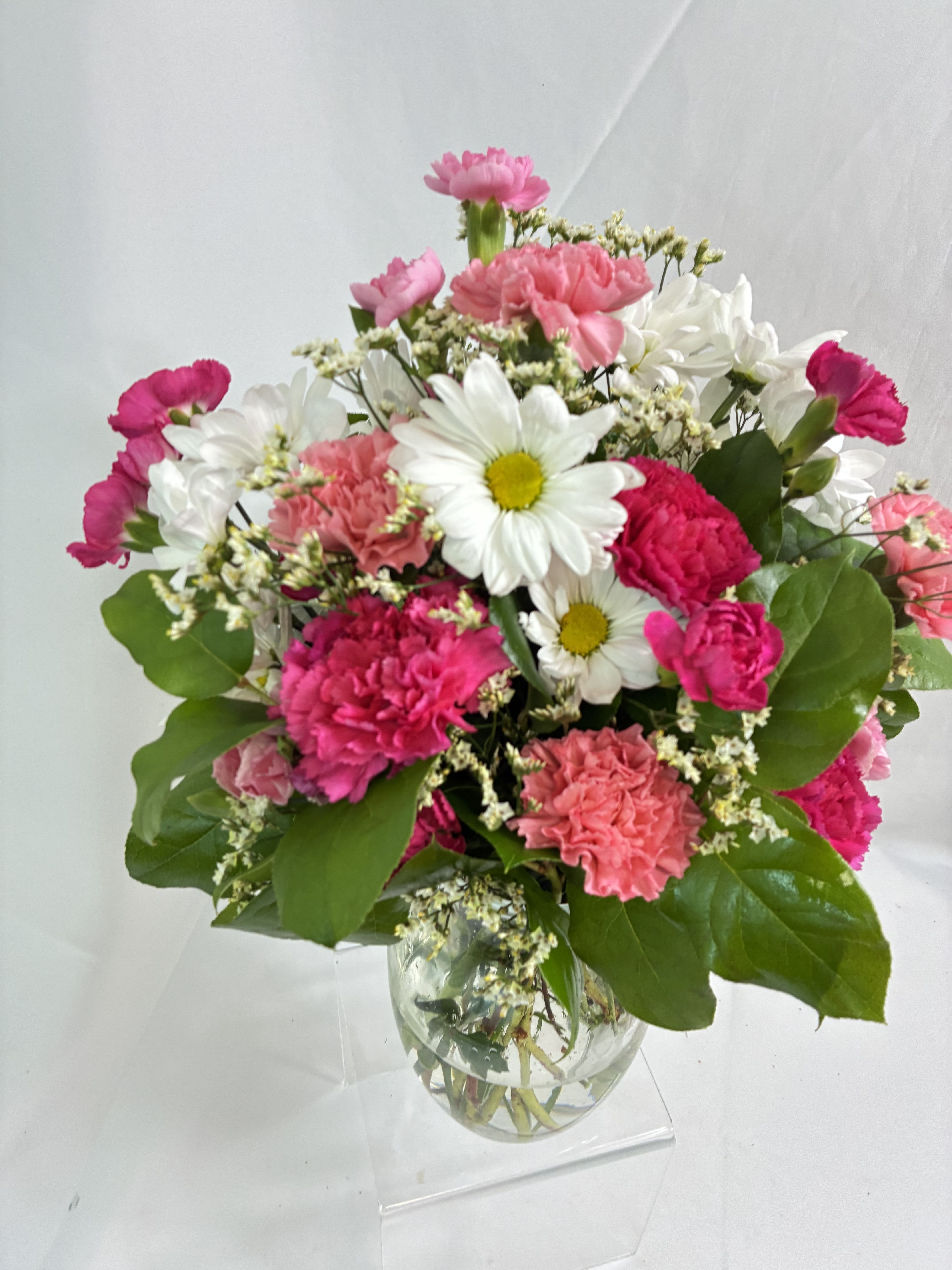 Love Me Dearly Bouquet  - This sweet, beautiful bouquet includes pink alstroemeria pink carnations hot pink miniature carnations white daisy spray chrysanthemums and accented with assorted greenery. Delivered in a clear glass rose vase.