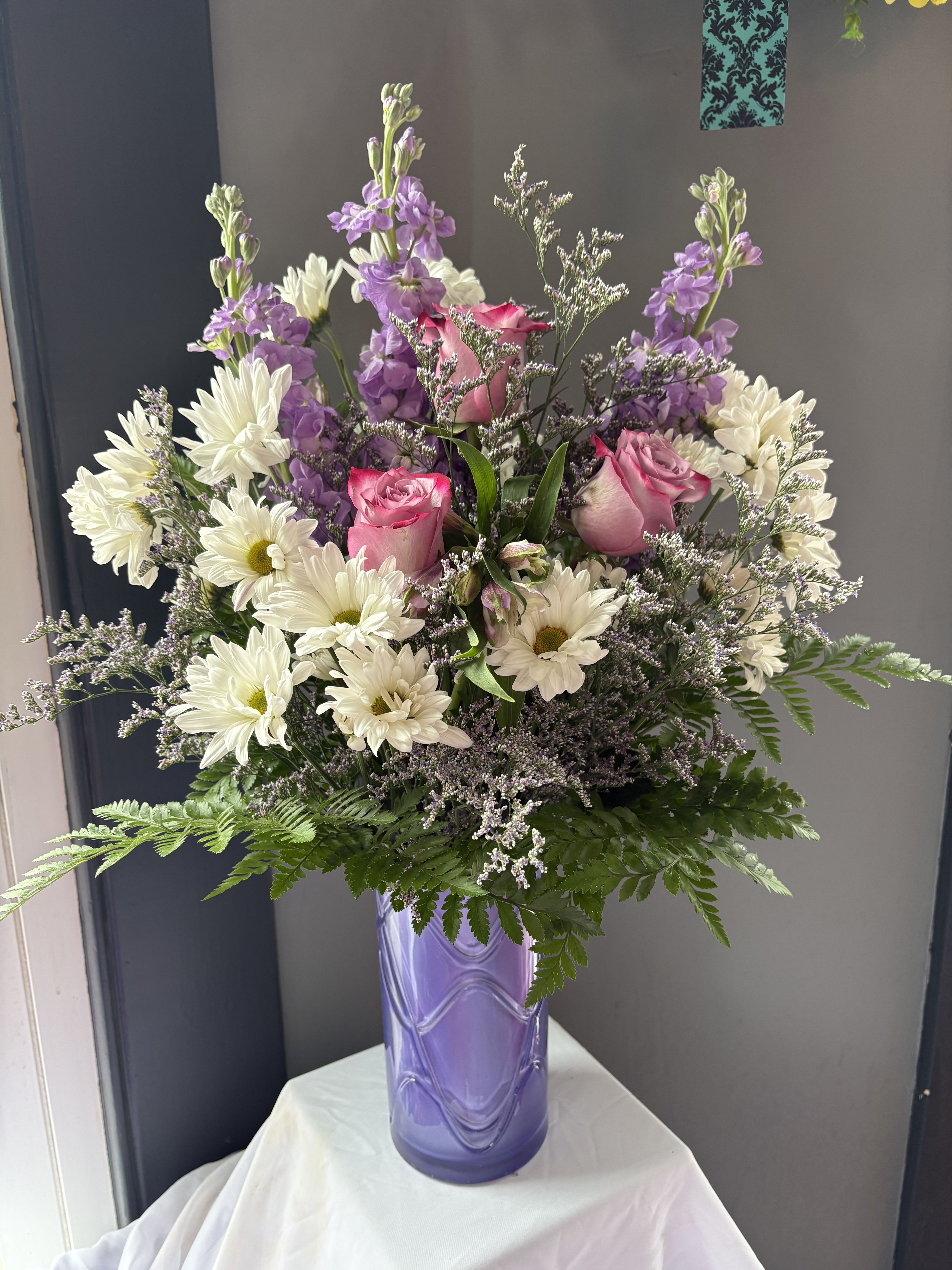 Frazier's Version Pretty Daydream Bouquet - Celebrate her sweetest moments with Frazier's Version Pretty Daydream Bouquet, a dreamy mix of soft, vibrant blooms beautifully arranged in Teleflora's Pretty Daydream Vase-a charming keepsake she'll enjoy long after Mother's Day. The scale of the arrangement should determine the type of substitution acceptable, but the substitution must be of equal or greater value and must maintain the style and color harmony of the original order.