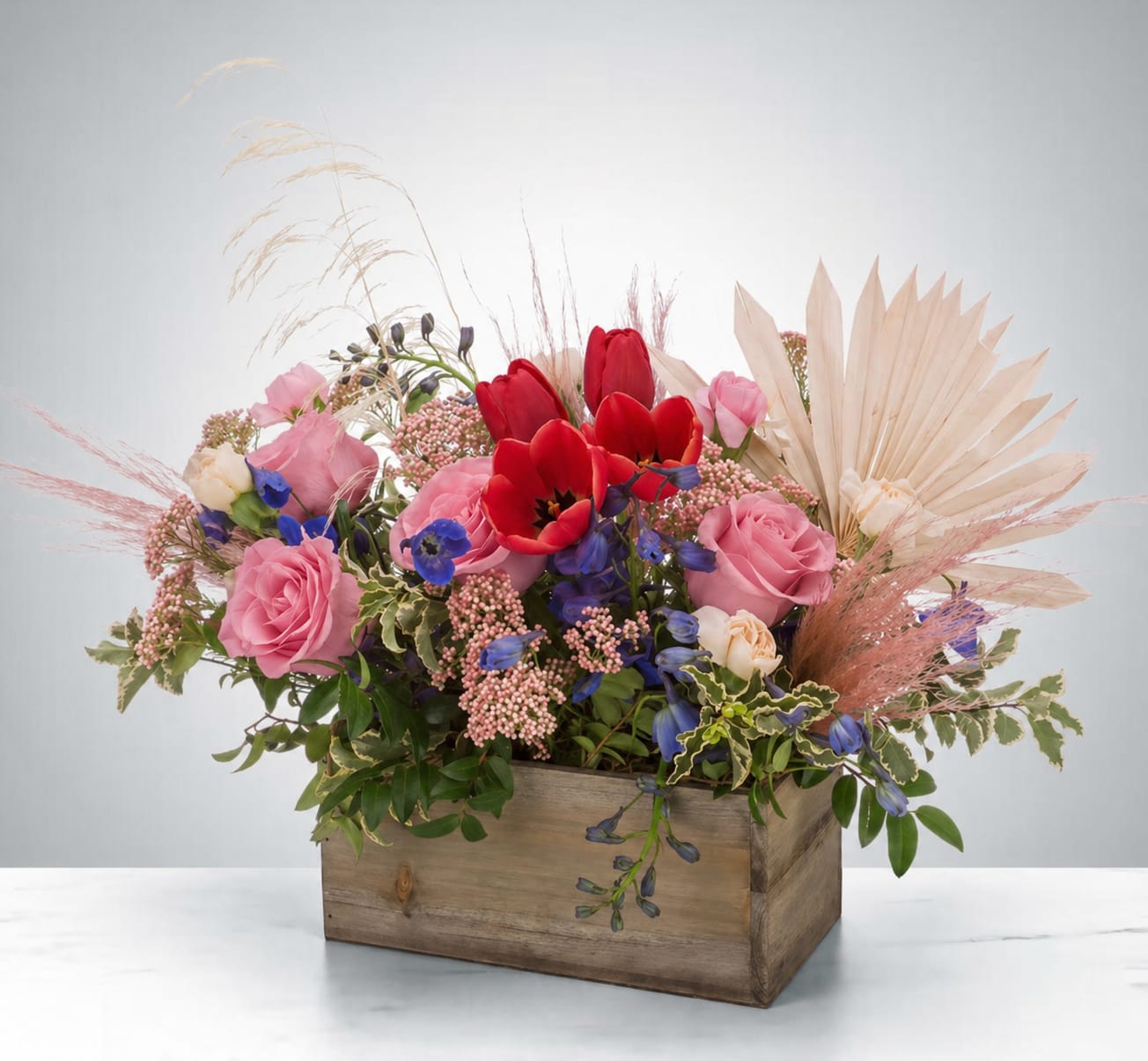 Wild and Free by BloomNation™ - A gift for your free-spirited, boho friend (crystals optional).  This trendy arrangement is a mix of dried and fresh materials like bright pops of tulip and a sun palm. The perfect good vibes gift.  Approximate Dimensions: 22"D x 15"H