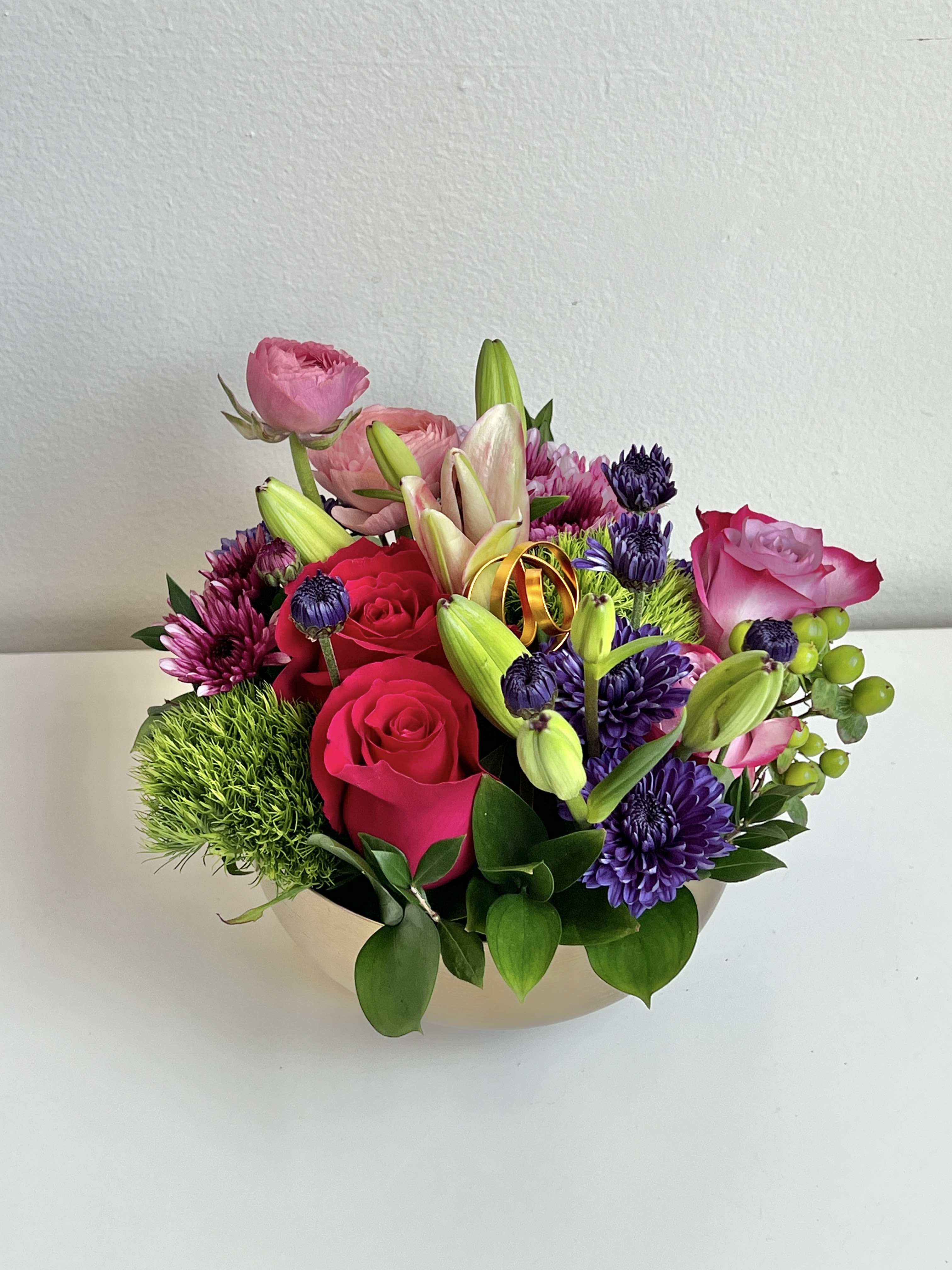 MD26-01 - A Pave' of Bright Colored Flower Blossoms, Berries and Foliages Desinged in a Short Metal Container.