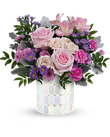 Pink roses and purple flowers arranged in a mosaic vase