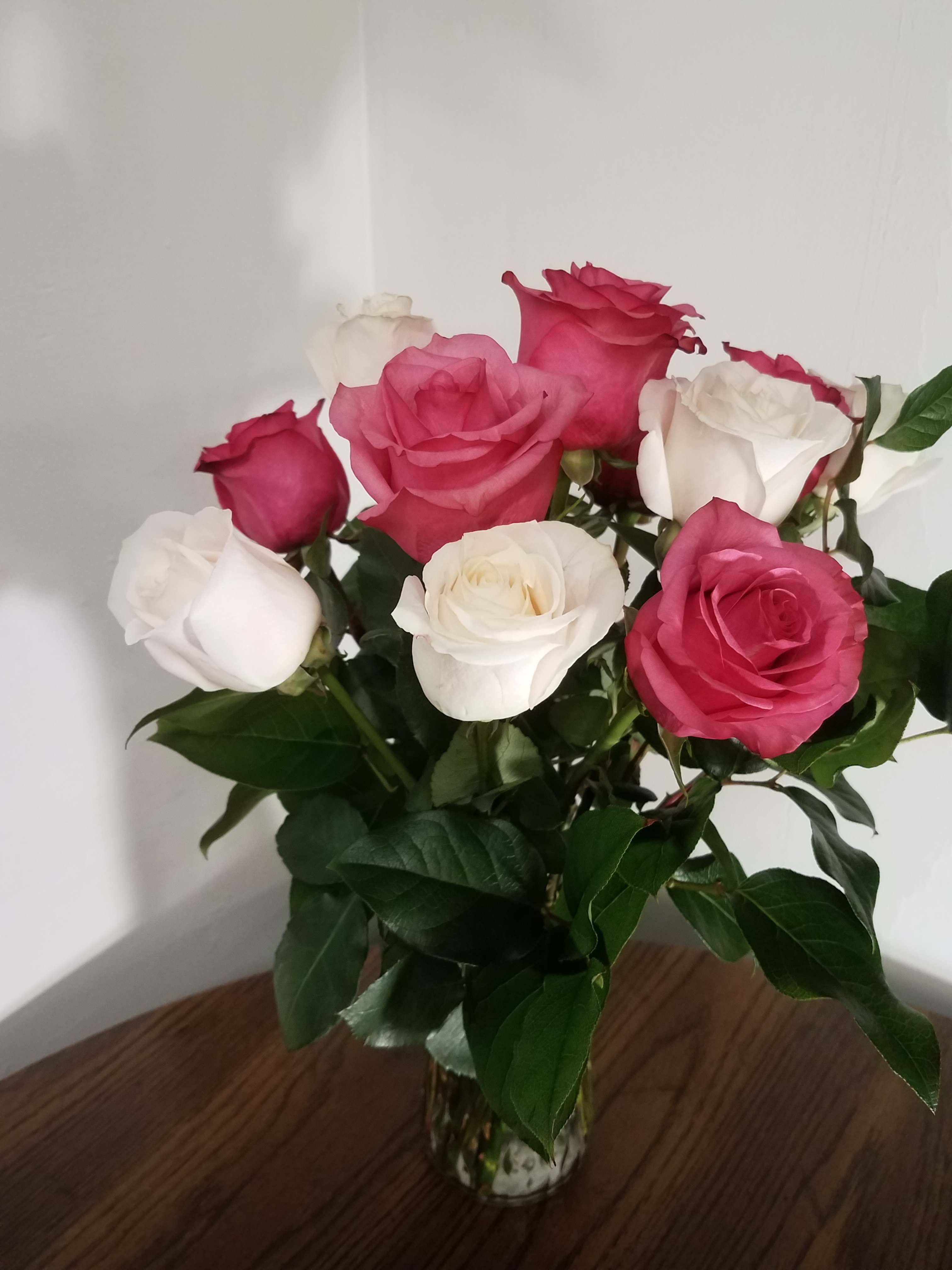 Bouquet of pink and white roses in a glass vase