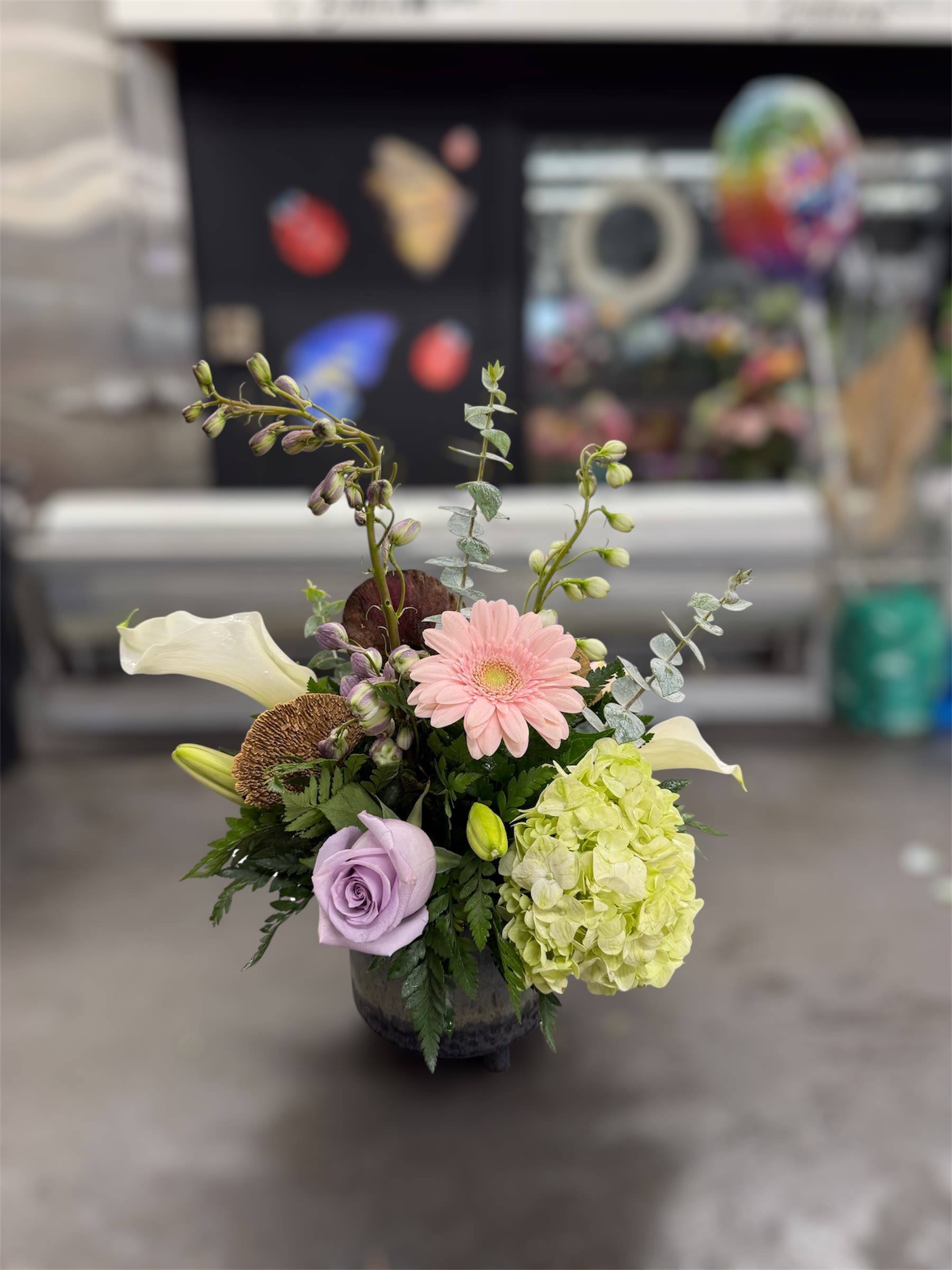 Designer's Choice Ceramic Container Arrangement - You're not sure what kind of flowers your receiver prefers? Allow our team of expert designers to create a Bouquet full of vibrant, beautiful blossoms made for any occasion! Using the freshest in season flowers, each unique custom made arrangement in this style is handcrafted and one-of-a-kind.
