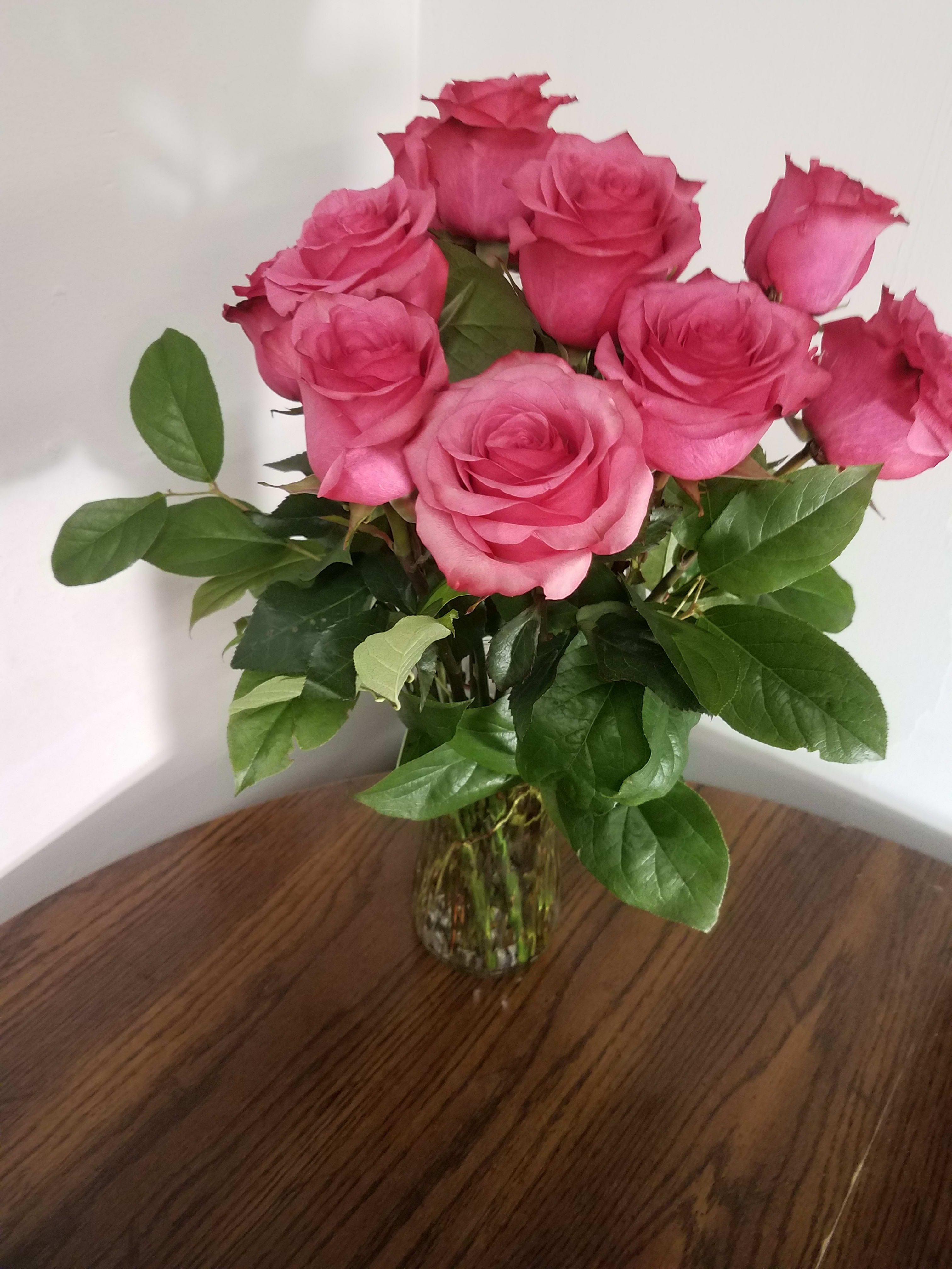 Pink roses in a clear glass vase