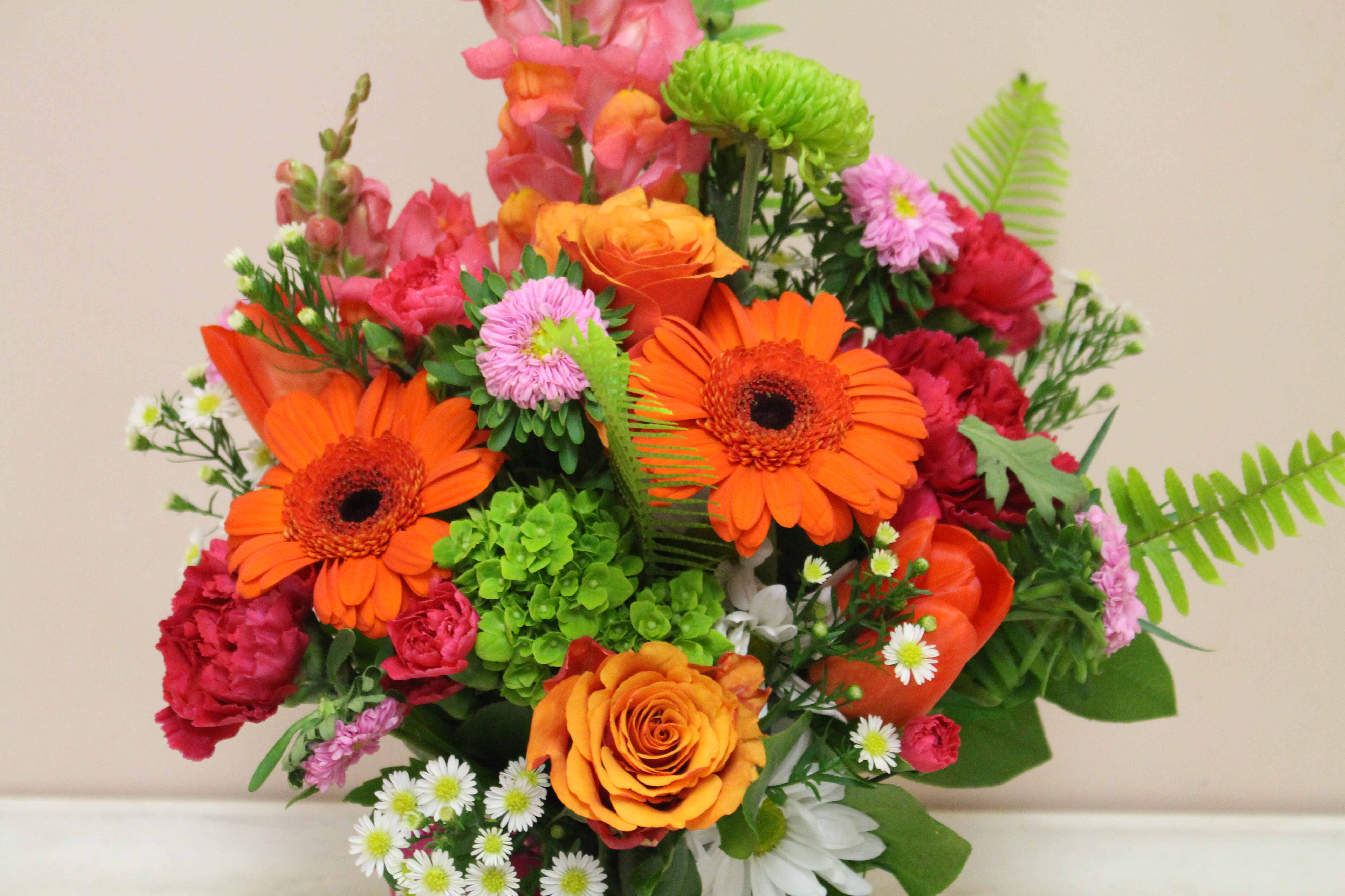 Bright mixed bouquet with orange gerbera daisies and roses