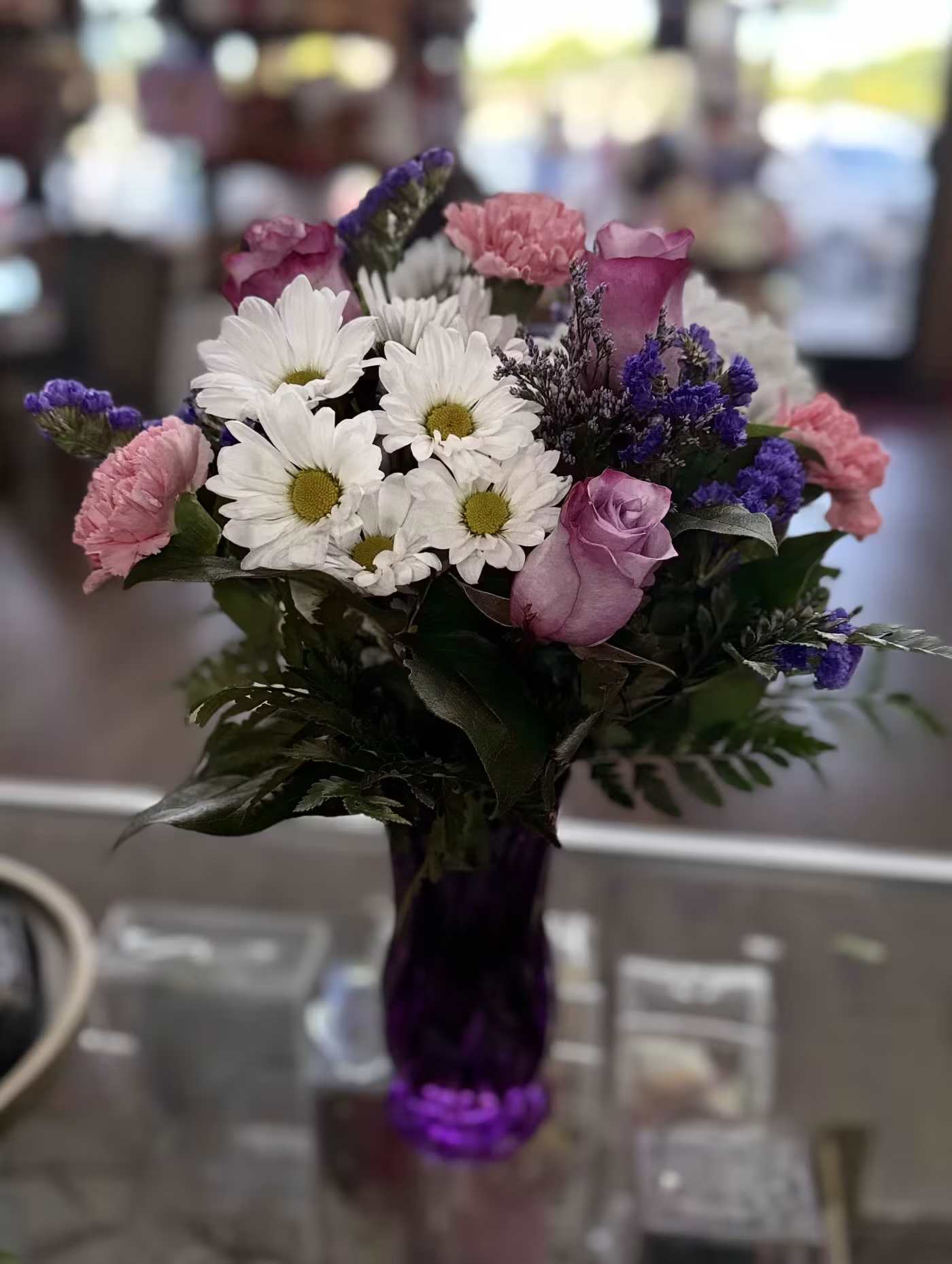 Daisy Delight - A purple vase with roses, daisies, carnations, and purple filler flowers for a flower loving mama.  