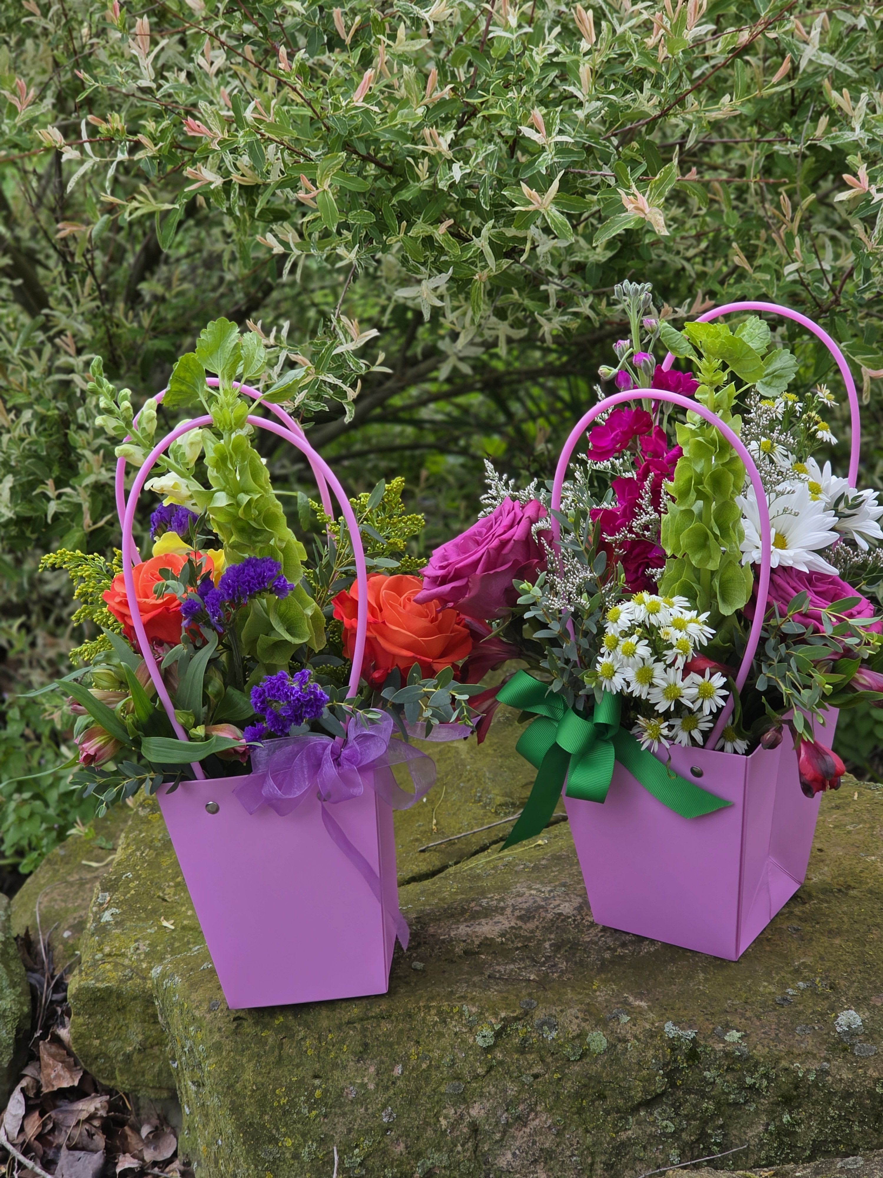 Grab and Go Market Basket - A fresh, designer’s choice arrangement tucked into a sturdy cardboard basket with a handle. It has that classic "just-picked" look without the hassle of a glass vase. Easy to carry, easy to gift, and fits perfectly on any countertop.