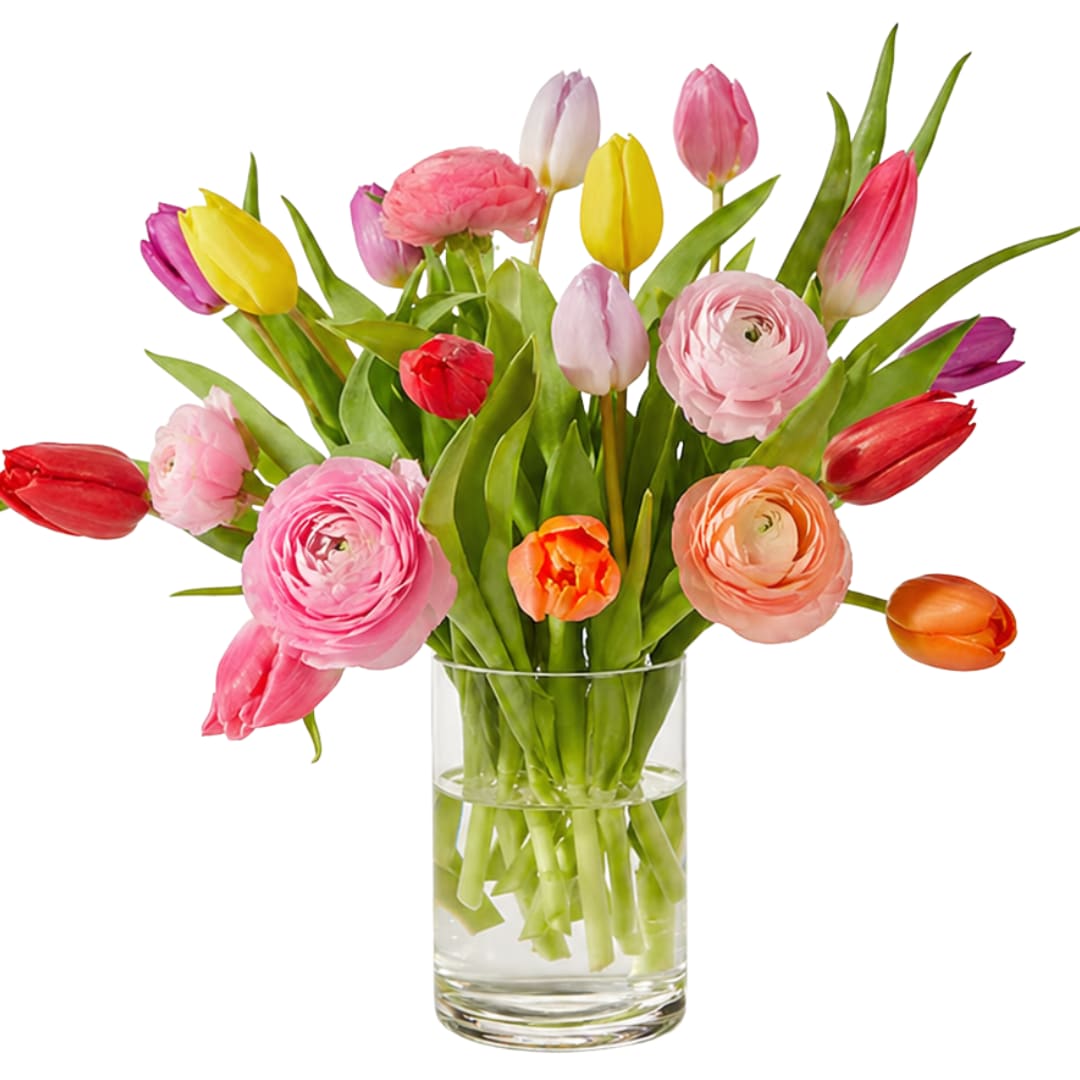 Bluegrass Garden  - Celebrate the beauty of the season with our Bluegrass Garden Arrangement, a fresh, garden-style design featuring a mix of tulips, ranunculus, and other seasonal blooms—sourced directly from Kentucky flower farms.  Designed in our signature loose, natural style, this arrangement highlights soft textures, cheerful color, and the charm of locally grown flowers at their peak. Each piece is thoughtfully arranged in a clear glass vase, making it perfect for gifting or brightening any space.