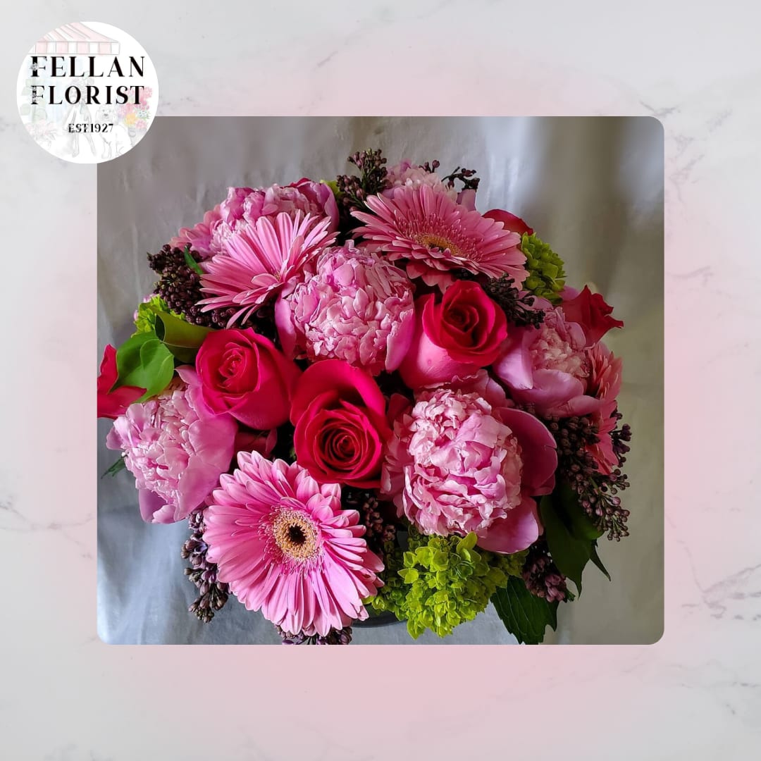 Giorgia  - beautiful seasonal arrangement with classic seasonal flowers such as peonies, roses, gerbera daisies in a beautiful glass vase with leaf inside