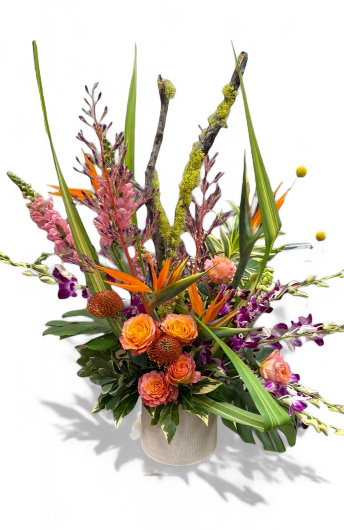 Tall tropical arrangement with orange roses and purple orchids in a vase