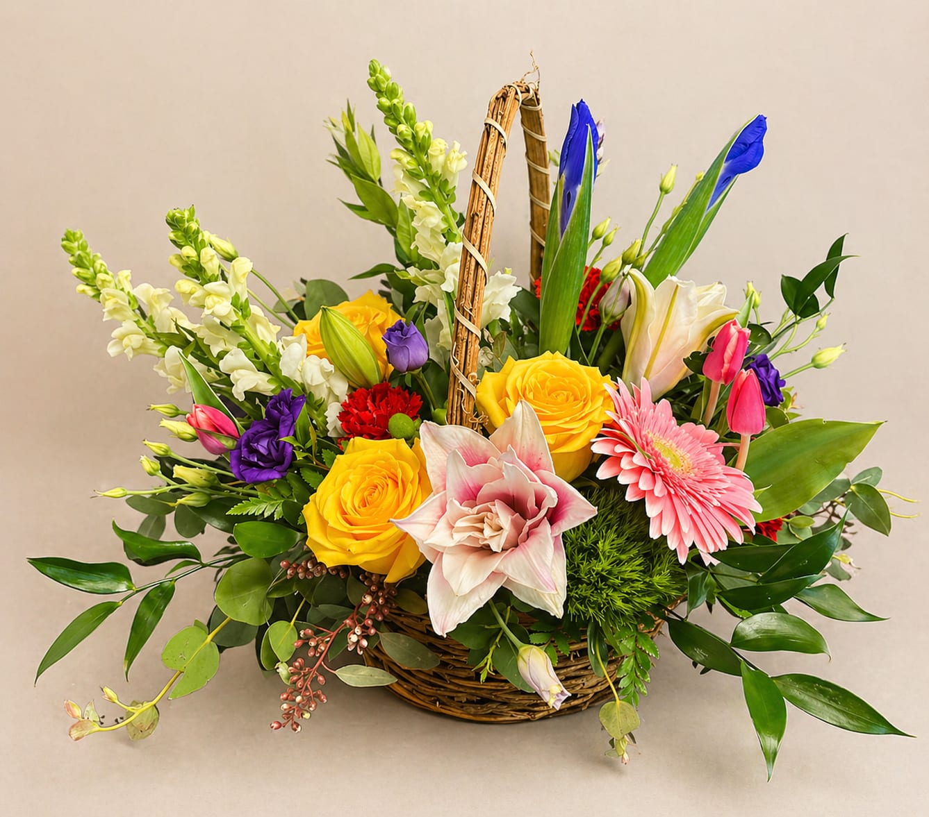 Mixed flower basket with yellow roses, lilies, gerbera daisies, and snapdragons