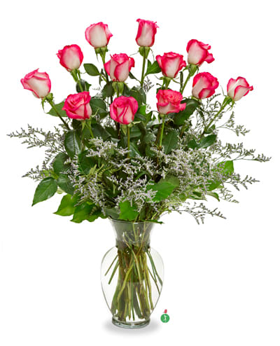 Pink and white roses arranged in a clear glass vase