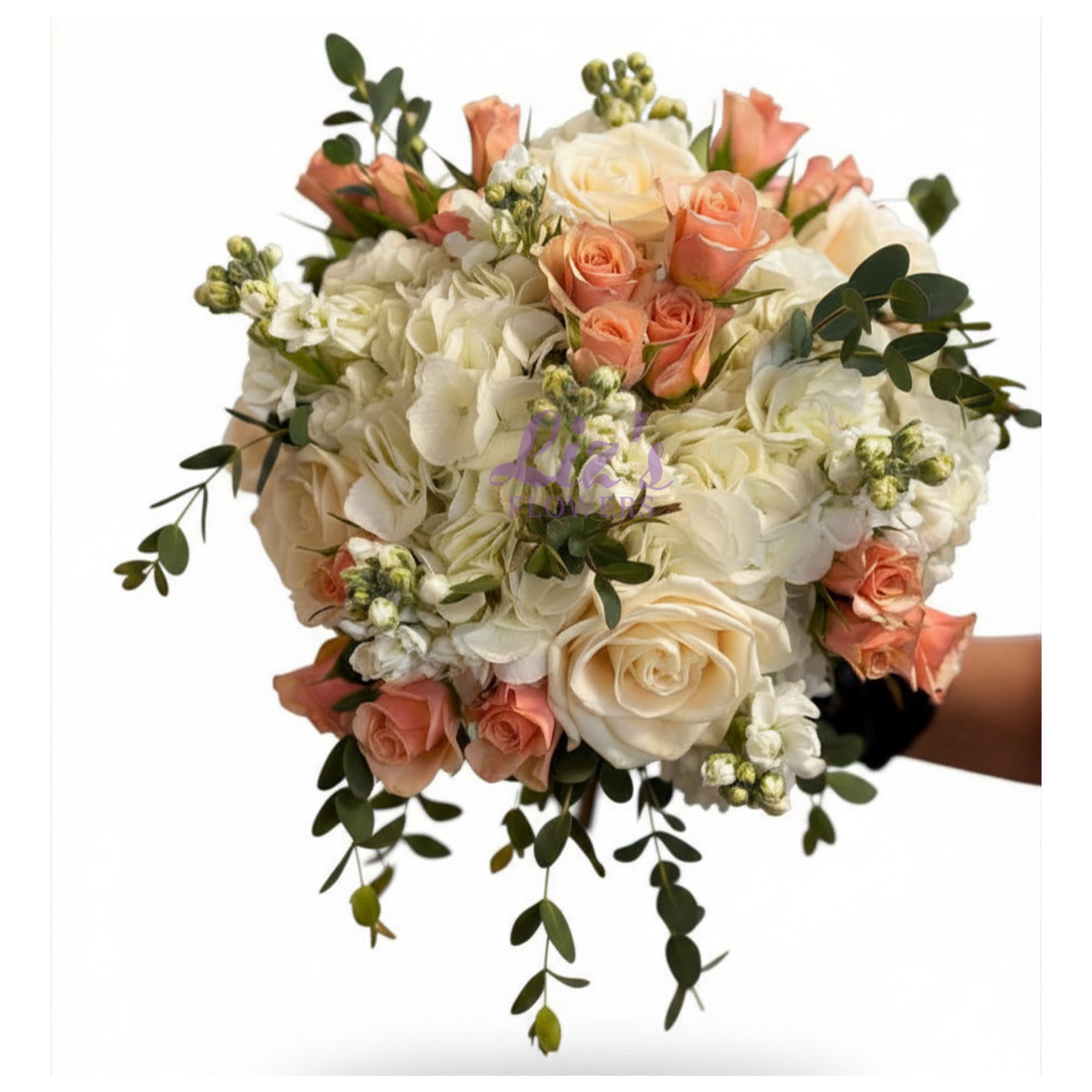 Peaches and Cream Bouquet - White roses and hydrangea with clusters of delicate peach roses, accented by small white stocks and trailing eucalyptus greenery.