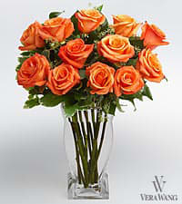 Orange roses arranged in a clear glass vase