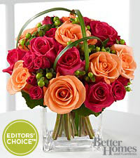 Bouquet of pink and peach roses in a clear vase