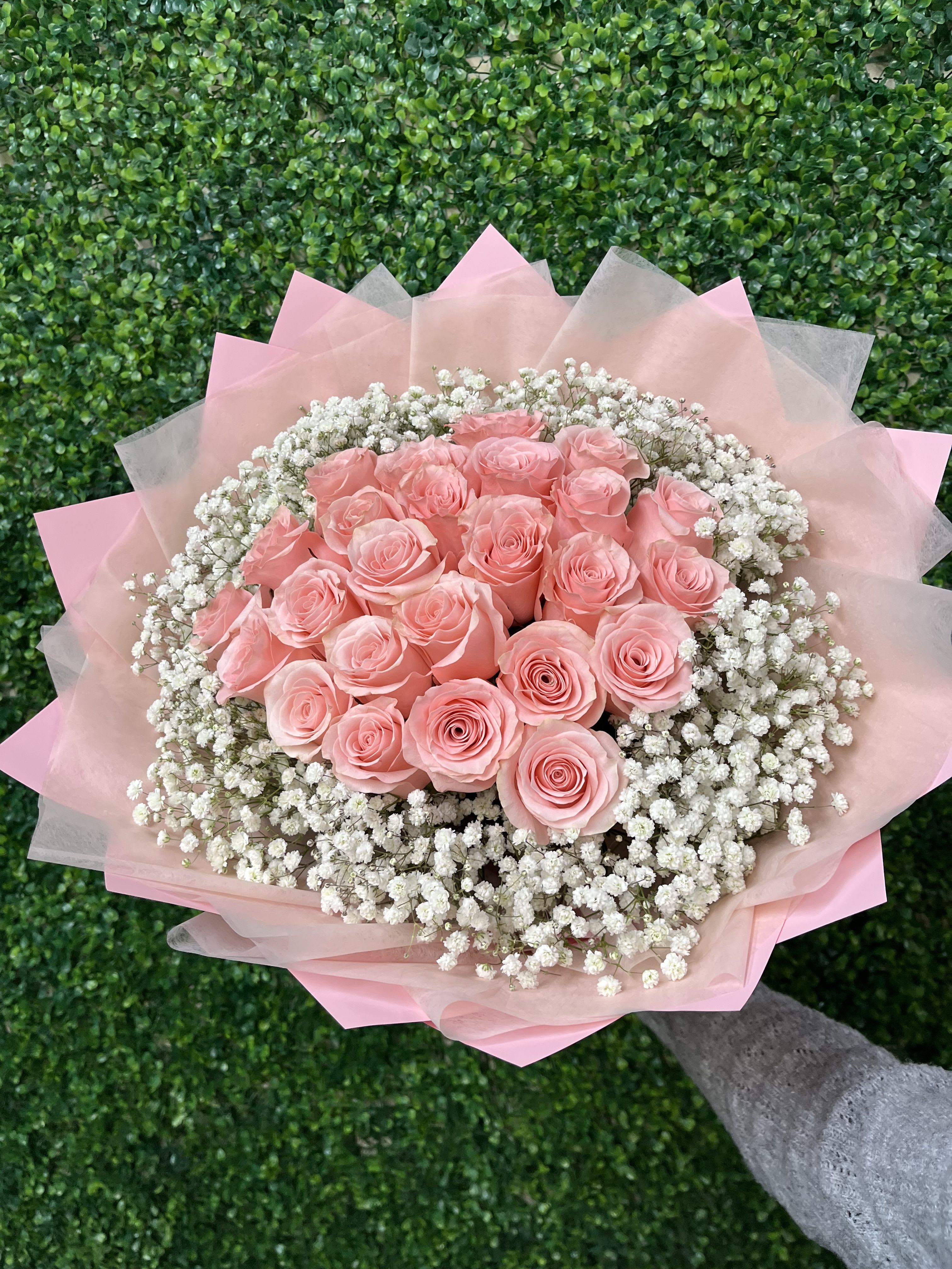 25 Pink Roses Wrap - 25 of our premium pink roses wrapped with babies breath all around. Accompanied by modern wrap. Upgrade your bouquet with a banner of 2 to 3 words to say what is in your heart. Due to availability and holidays , pink roses might be a different shade of pink. If this is a concern please note it in special notes section upon ordering. (Banner Sold Separately) Wrapping paper might change upon availability to match flowers.