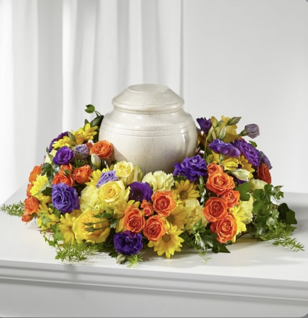 Sunrise  - This urn arrangement has dark purple lisianthus, yellow daisies, yellow carnation, yellow roses, orange spray roses, solidago and greenery. Please note arrangement does not come with urn. 