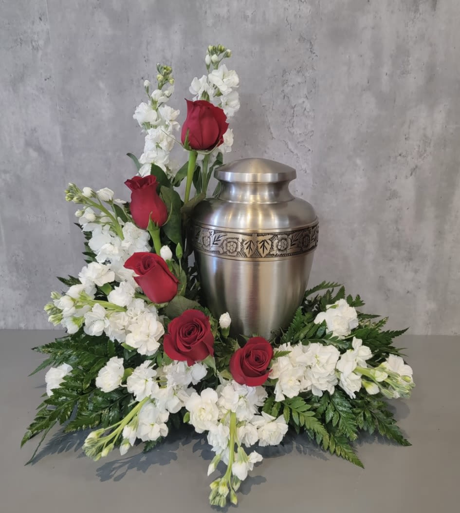 Red and white Tribute  - This arrangement has white stock, red roses, white mini carnations and greenery. Urn not included 
