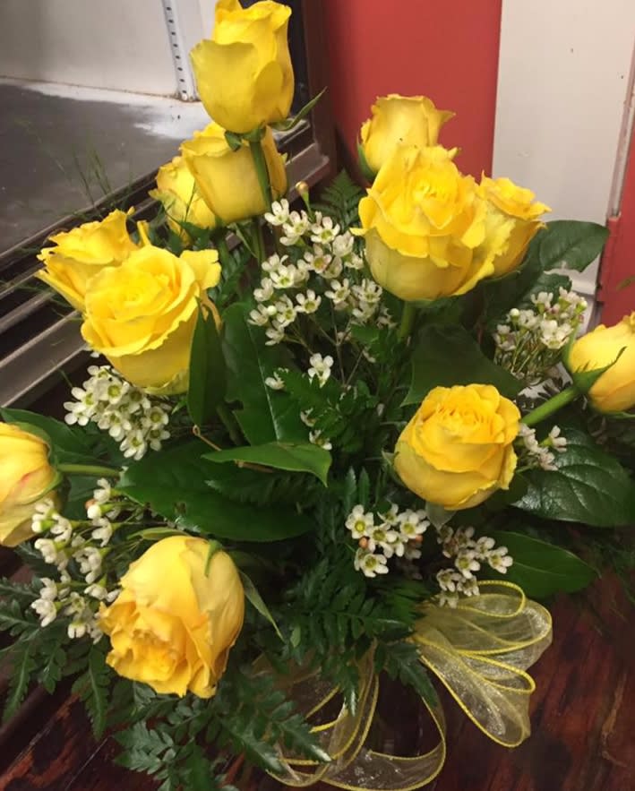 Bouquet of yellow roses with small white filler flowers