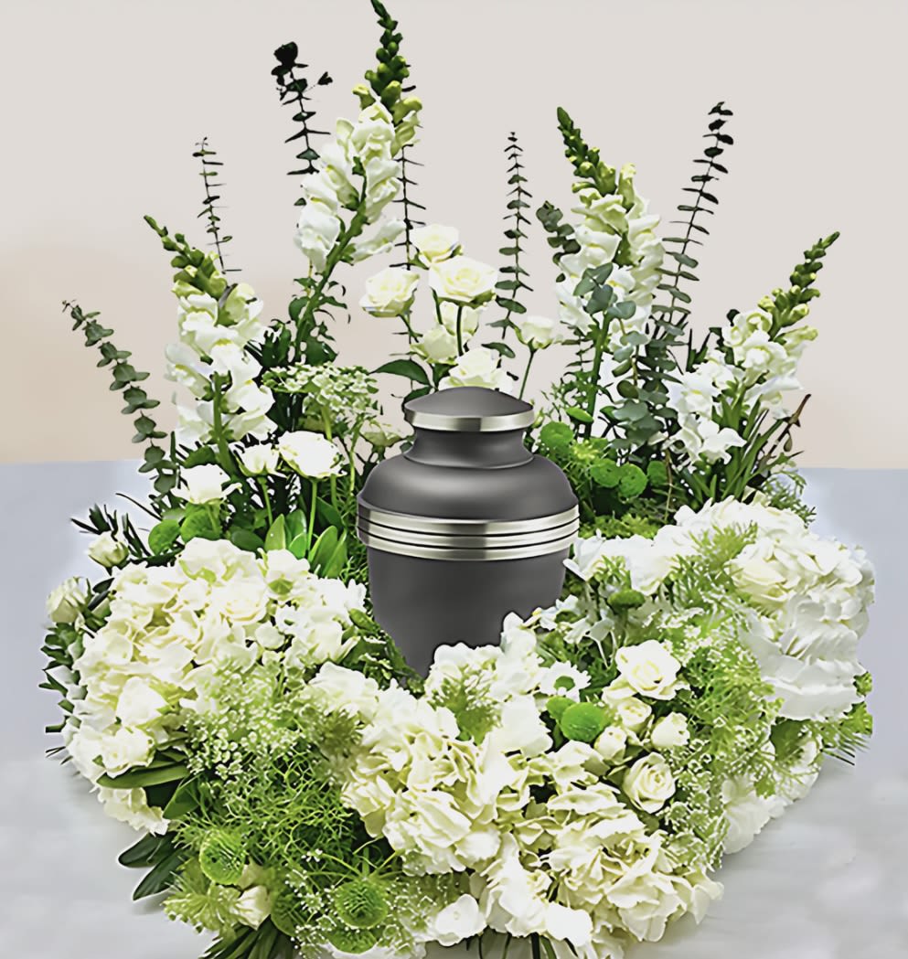 Heavens Gates  - This arrangement has snap dragons, spray roses, hydrangeas, green buttons, daisies, Queen Anne lace, spiral, eucalyptus, and greenery. The photo shown above is the premium size. Urn is not included. 