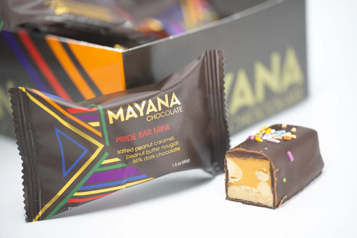 Mayana Pride Bar - Description:  The Pride Bar is the perfect combination of salty and sweet. Layers of our decadent salted peanut caramel and rich peanut butter nougat meet and are covered in dark chocolate.  Contains: Milk, soy, eggs, and peanuts.   May Contain: Traces of wheat and tree nuts. 