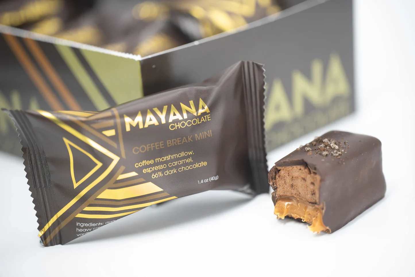 Mayana Coffee Break Bar - Description:  Look forward to your next coffee break with this delicious candy bar flavor! Layers of coffee marshmallow and espresso caramel are coated with dark chocolate and adorned with sea salt and ground coffee.   Contains: Milk, soy.  May contain: Traces of wheat, eggs, tree nuts, and peanuts