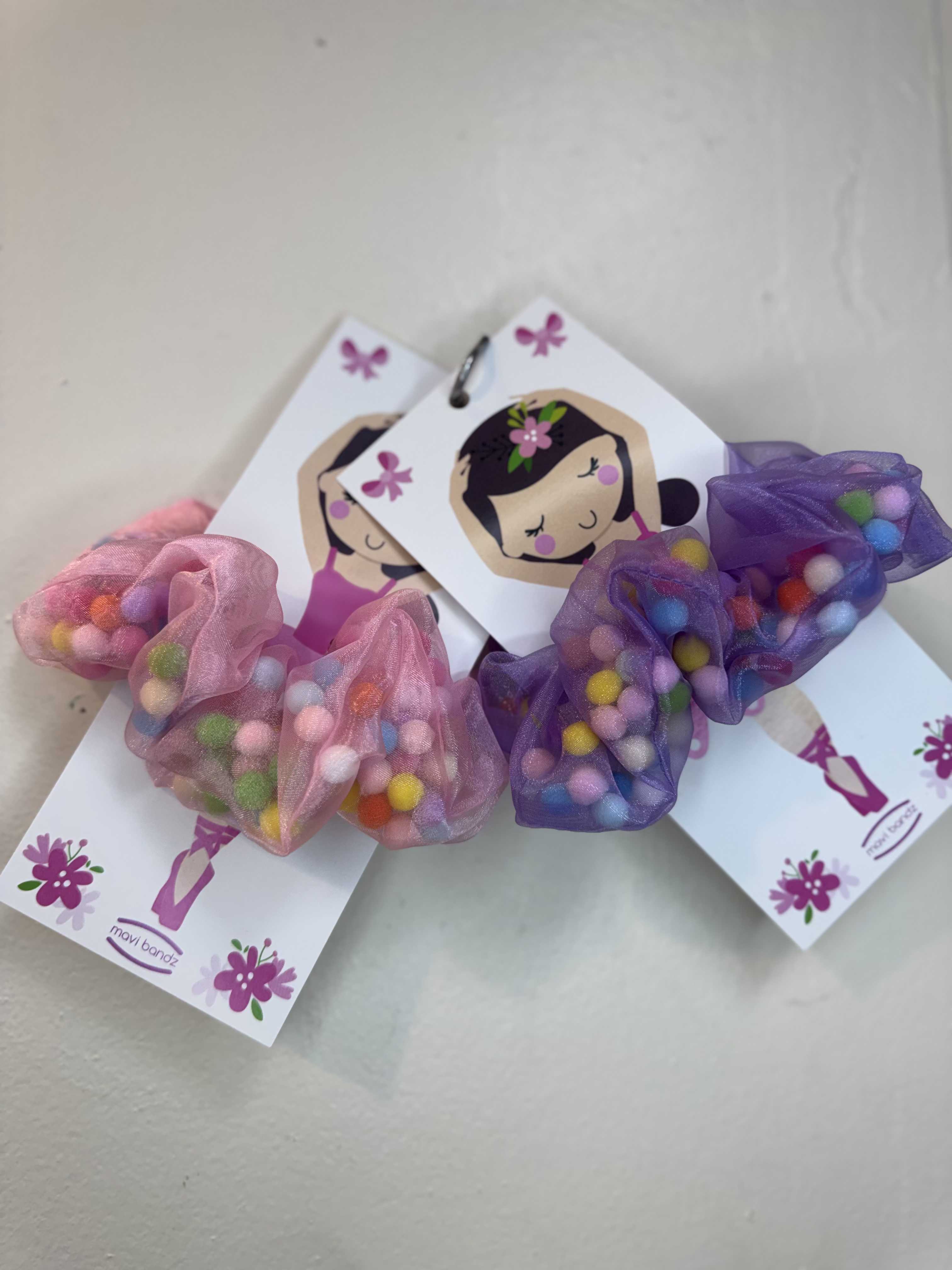 Pom Pom Ballet Scrunchies - Colorful pom pom ballet scrunchies made with soft sheer ribbon and playful pastel accents. The perfect accessory for dance recitals, gifts, and everyday sparkle. 