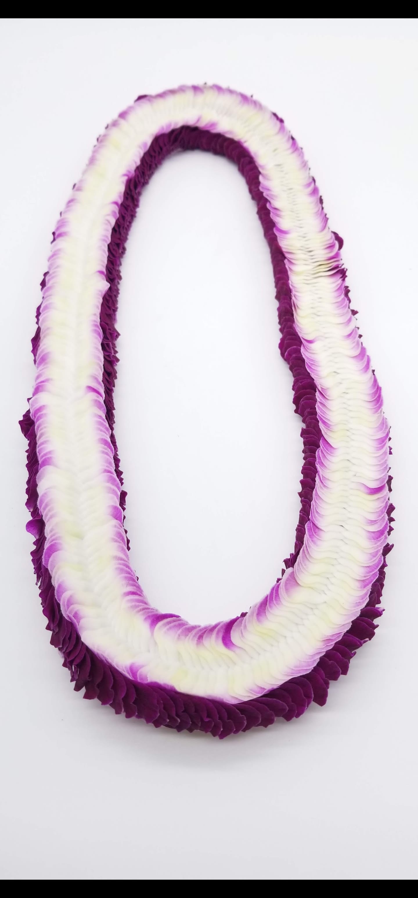 Purple and white flower lei on a white background