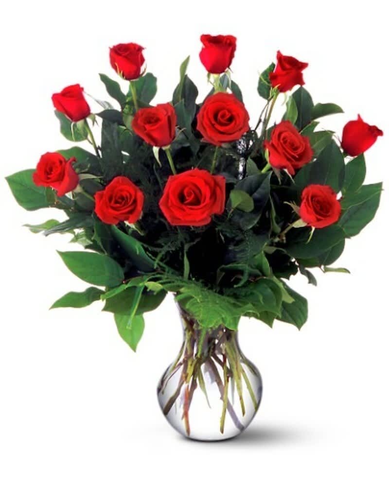 Dozen red roses arranged in a rounded clear glass vase