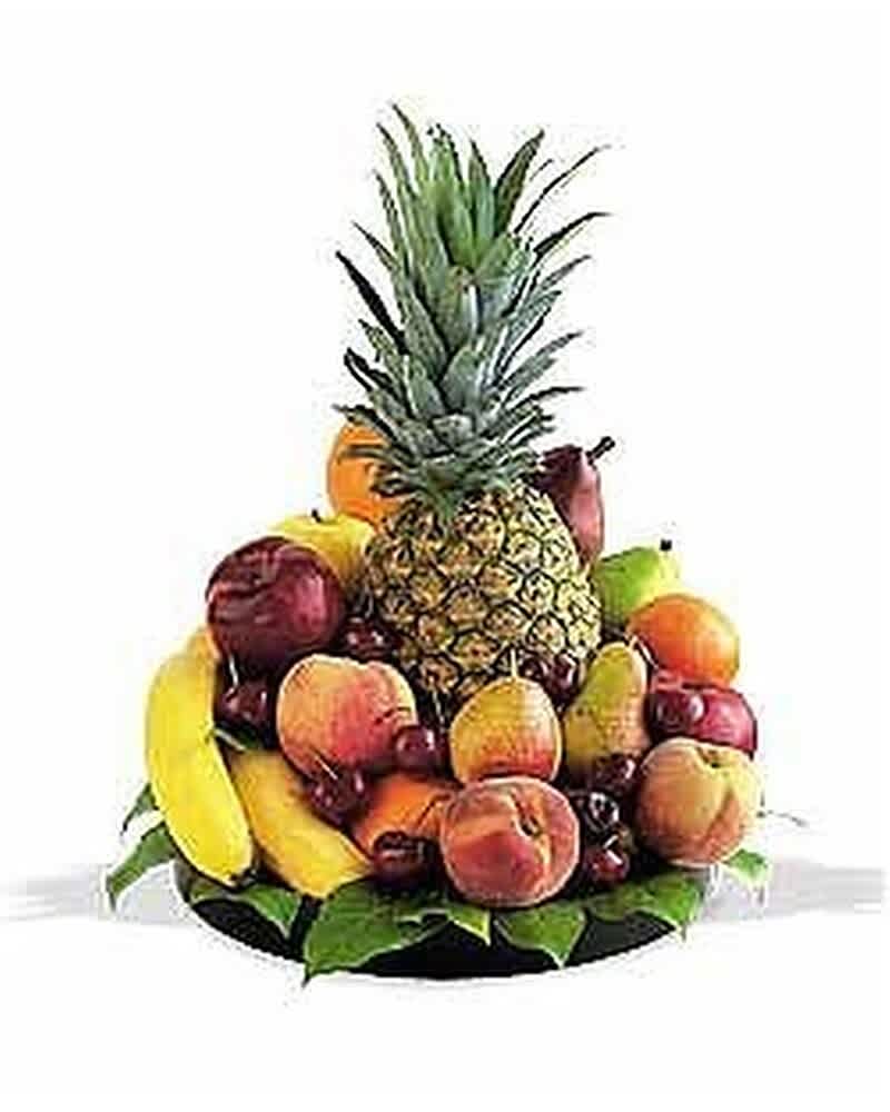 Assorted fresh fruits arranged around a tall pineapple on a platter