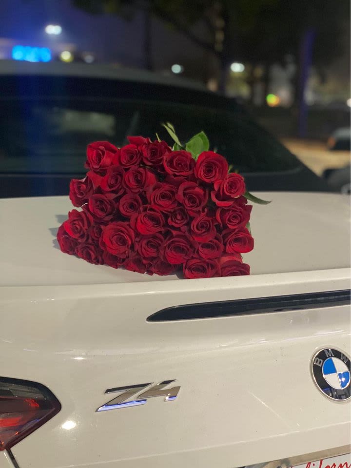 Florist Choice 25 stem rose bouquet - This will be a florist choice of color on a simple beautiful 25 stem bouquet that is cleaned of any excess leaves and thorns, wrapped with a matching ribbon. It may be all one color or mixed colors of roses that match well together. 