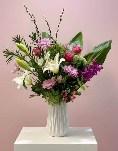 Delicate Harmony Garden - A tall, garden-inspired arrangement designed with a balanced blend of layered blooms and natural texture. Featuring a graceful mix of seasonal flowers and lush greenery, it creates an airy, elevated presence with soft movement and height. Refined and versatile, it offers a comforting yet sophisticated expression—perfect for both everyday moments and heartfelt occasions.
