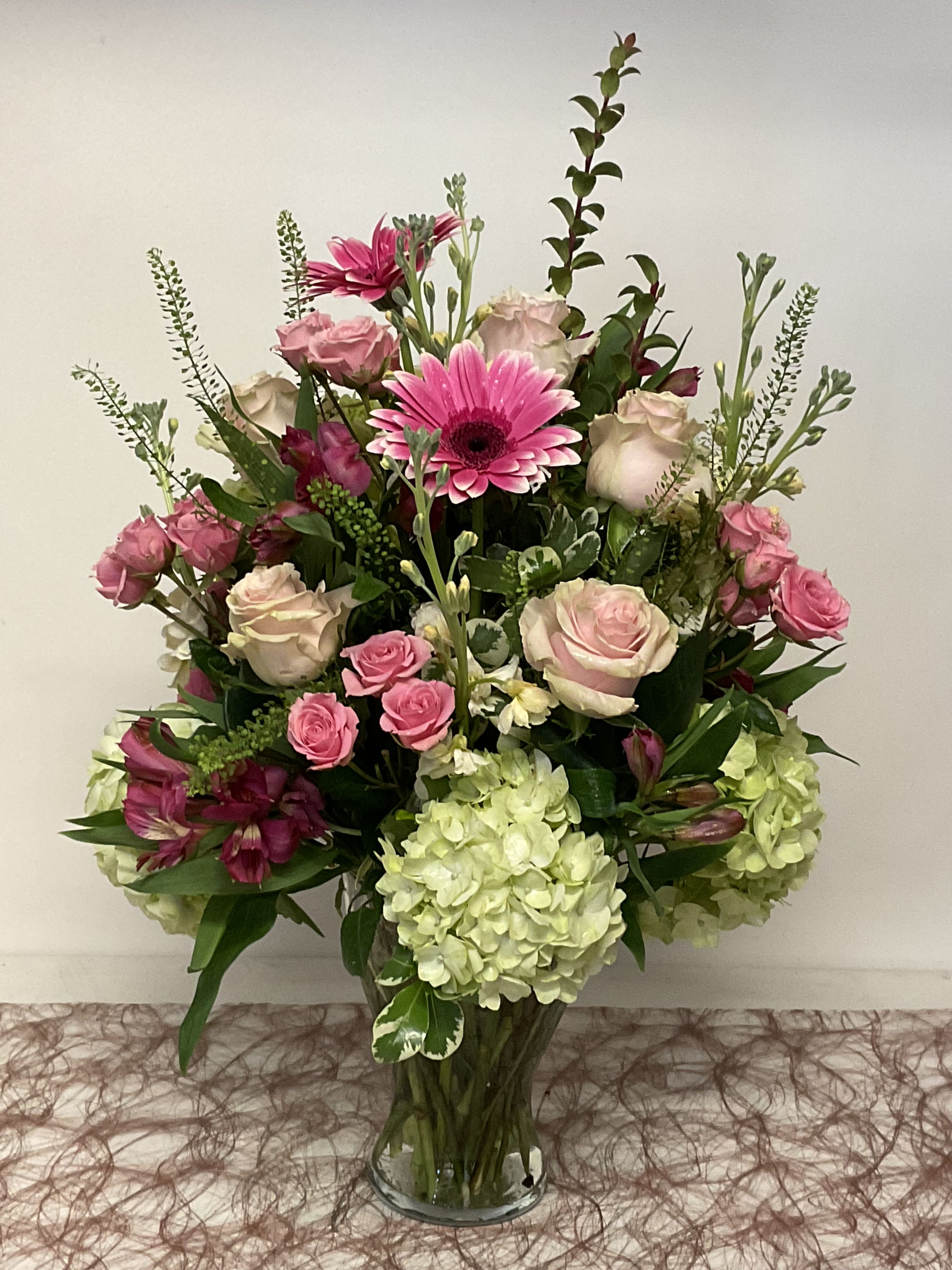 26-128 - Large upright mixed bouquet with pink gerbera, roses, green hydrangeas in a clear glass vase, garden-style fullness