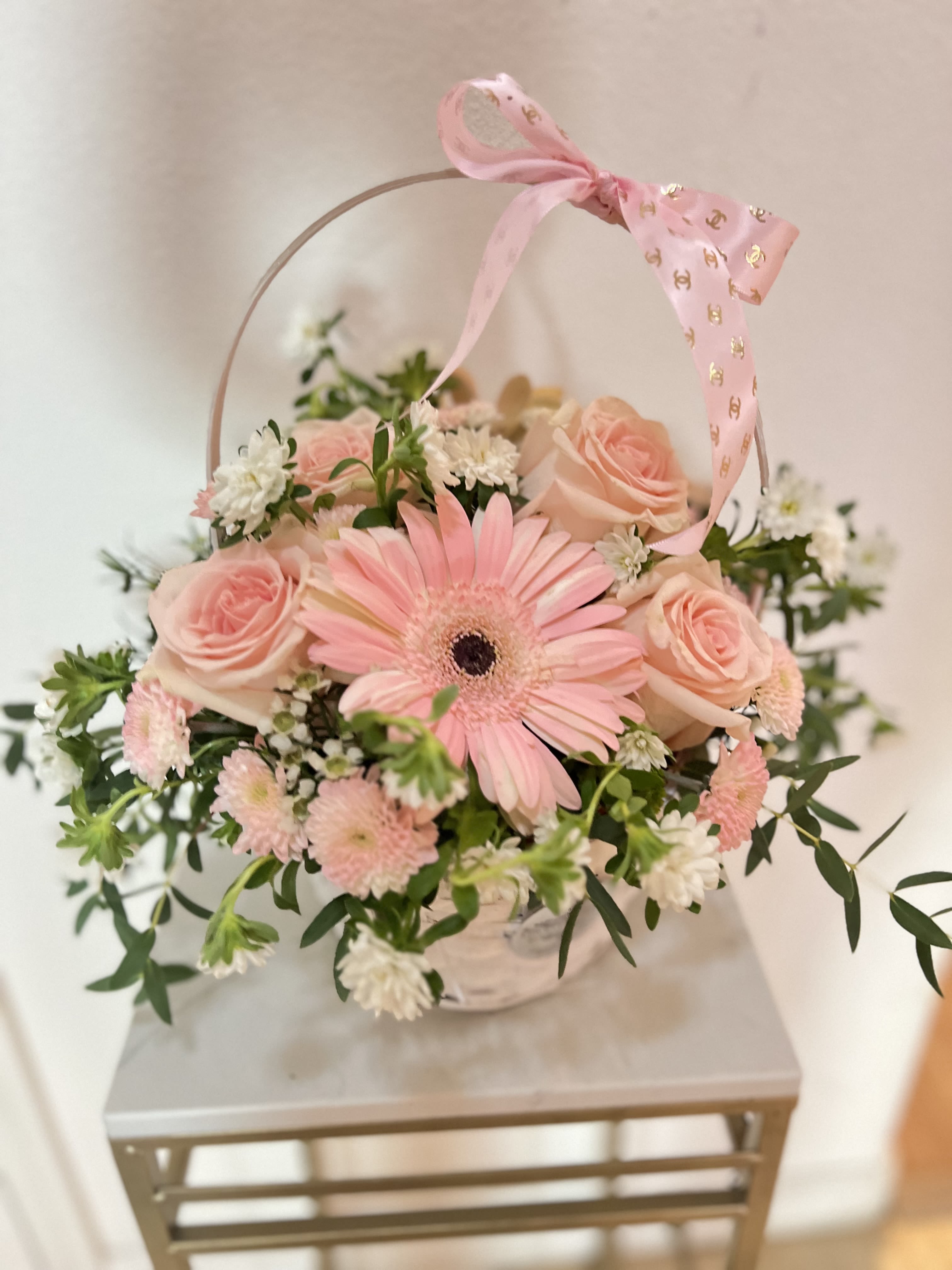 Blush &amp; White Signature Flower Basket - Blush &amp; White Signature Flower Basket Experience the charm of a cottage garden with our Blush &amp; White Flower Basket. This exquisite floral gift basket features a premium selection of blush pink roses, a focal pink gerbera daisy, and delicate white chrysanthemums. Nestled in a rustic-chic white woven basket and topped with a designer ribbon, this arrangement is the perfect all-occasion floral gift. Whether you’re looking for a get well soon basket, a thank you gift, Mother’s Day or decorative floral centerpiece, this arrangement offers a timeless, whimsical appeal that brightens any space  