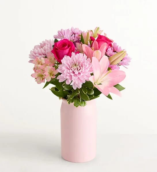 Mother’s Embrace 213357 - Thank Mom for a lifetime of comforting hugs with our Mother’s Embrace™ bouquet. Lovely pink and lavender blooms are hand-designed in a pink ceramic vase, creating a heartfelt expression of your feelings whether you're celebrating Mother’s Day together or sending a smile from miles away.