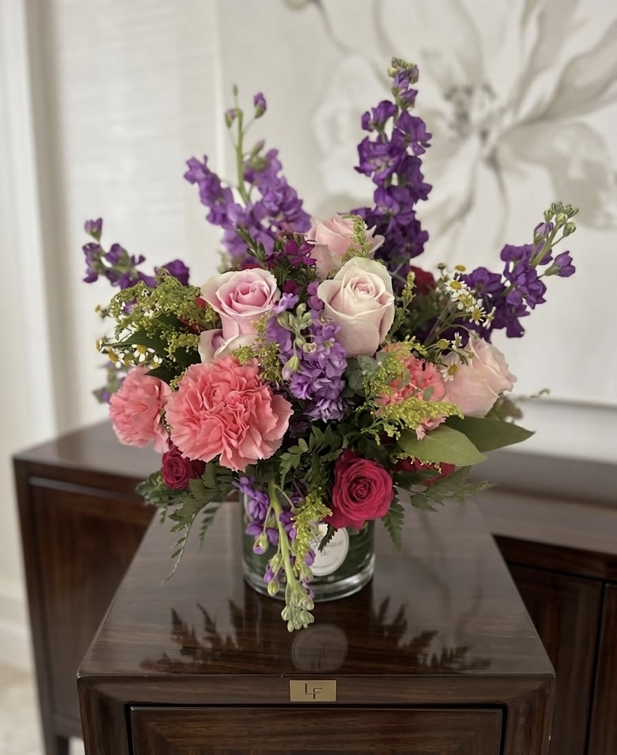 Purple Larkspur Arrangement - Elevate your space with our Radiant Garden Luxe arrangement. This premium floral design features a vibrant mix of pink roses, lush carnations, and striking purple larkspur. Expertly styled in a clear glass vase, this artisan flower arrangement brings a sophisticated, garden-fresh feel to any room. Whether you need a luxury gift or a stunning table centerpiece, this bouquet is a perfect choice for birthdays, anniversaries, or just because. • Fresh Flower Delivery: Hand-arranged with the highest quality seasonal blooms. • Vase Arrangement: Arrives ready to display in a modern cylinder vase.
